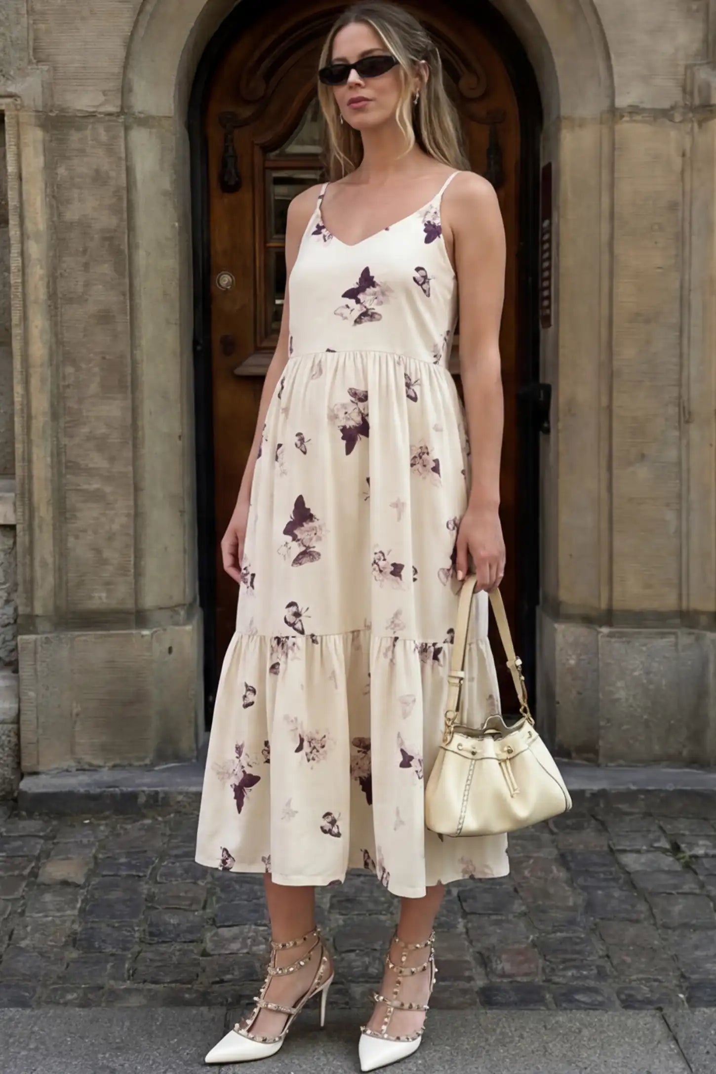 Butterfly Print Tiered Maternity Midi Dress in Beige Brown featuring a V-neckline and spaghetti straps on a pregnant woman.