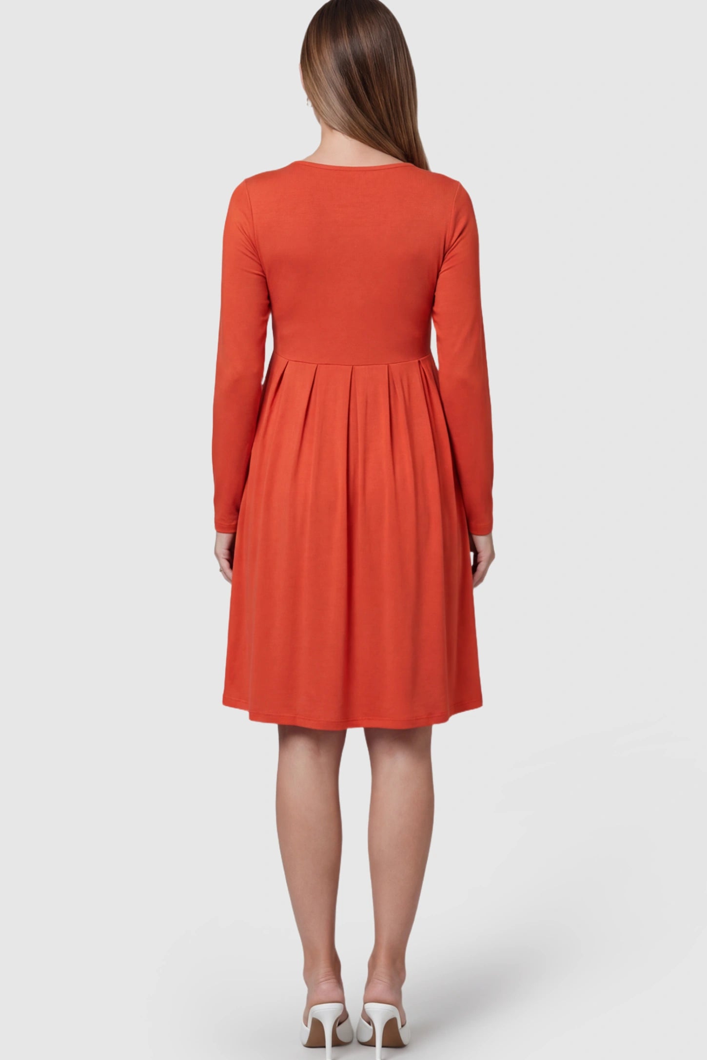 Button Accent Empire Waist Maternity Short Dress Button Accent Pleated Empire Waist Maternity Short Dress in Orange featuring long sleeves on a pregnant model showing back.