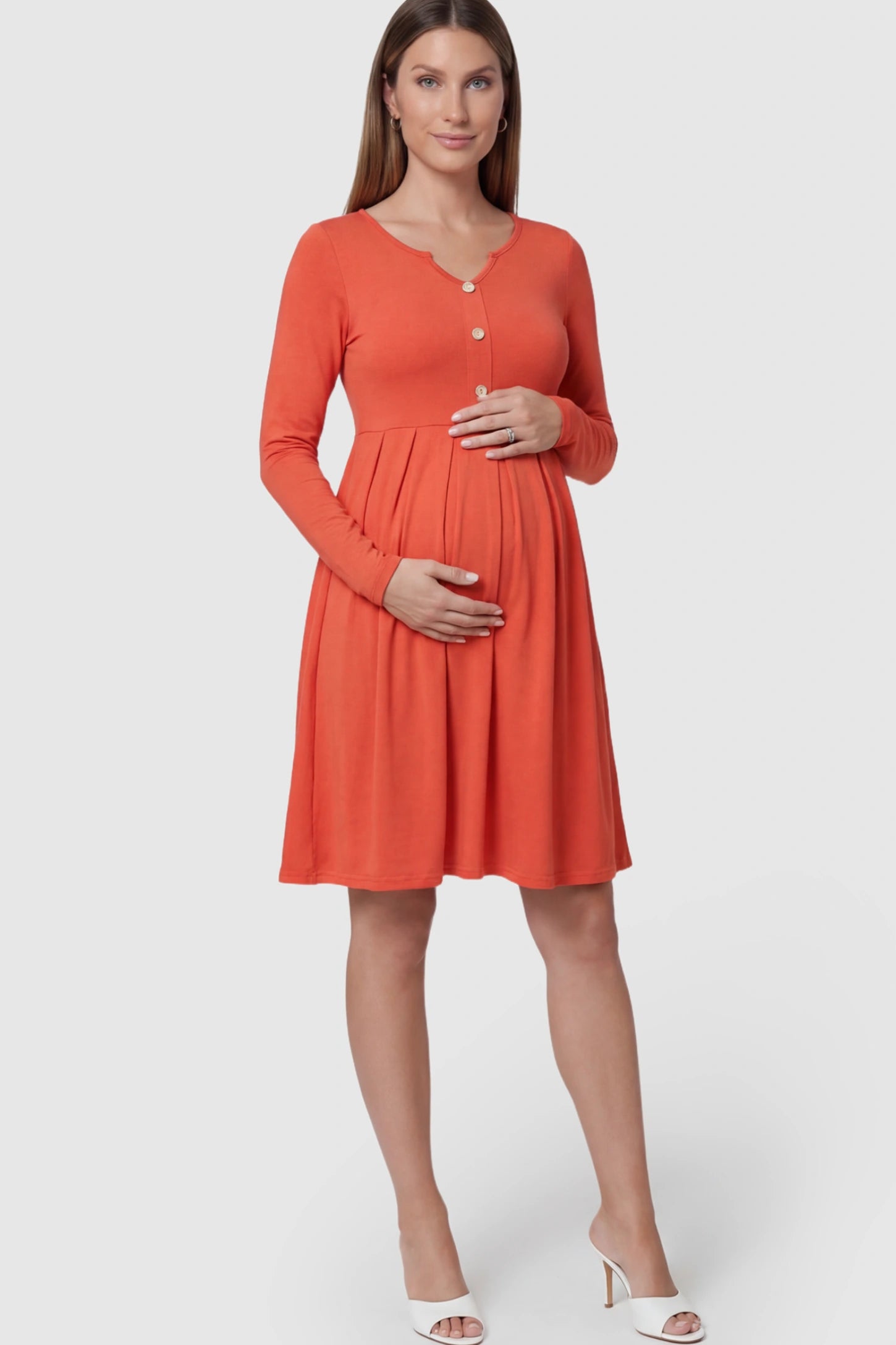 Button Accent Pleated Empire Waist Maternity Short Dress in Orange featuring a high-set waist on a pregnant model showing front.