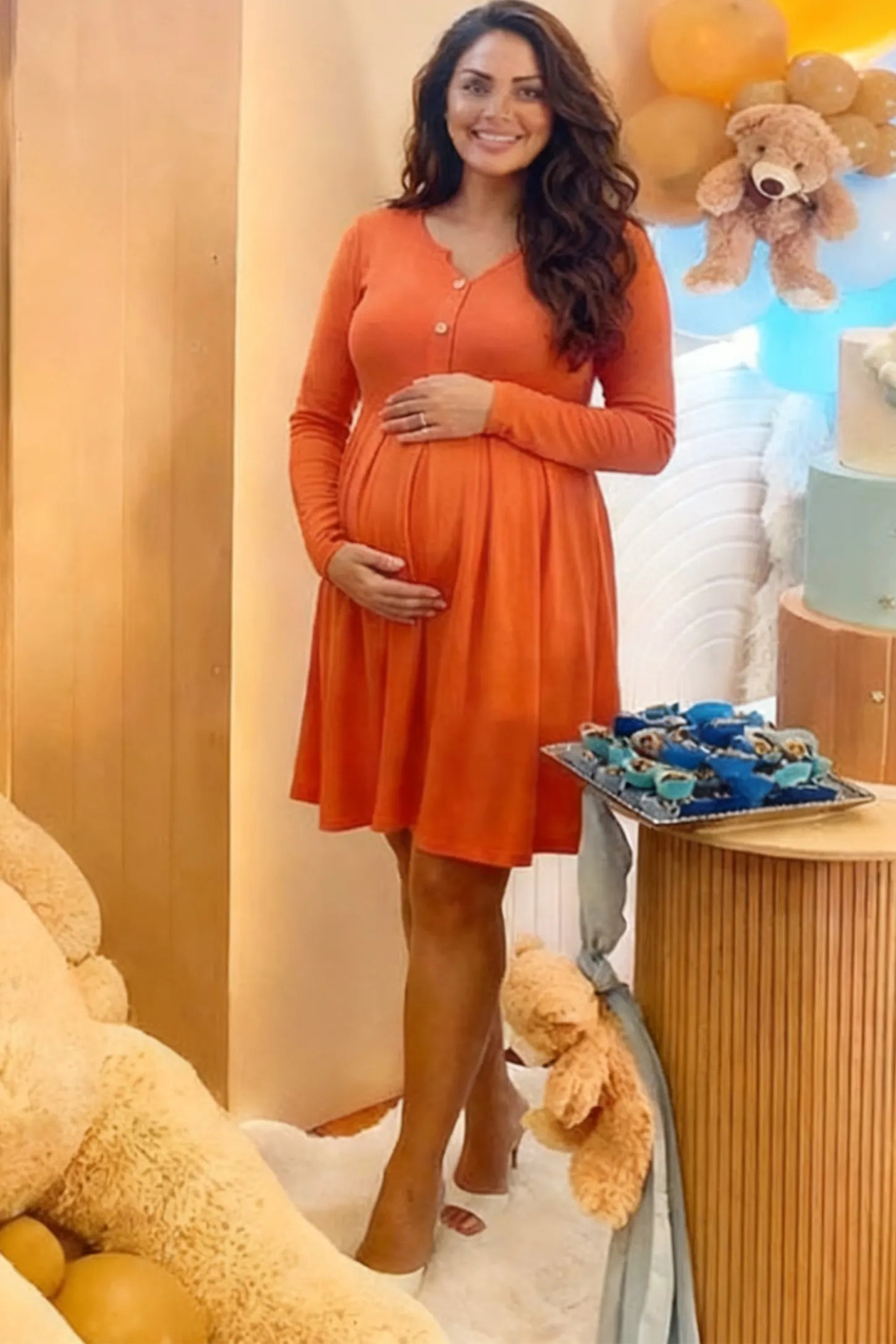 Button Accent Pleated Empire Waist Maternity Short Dress in Orange featuring a high-set waist on a pregnant model showing front.