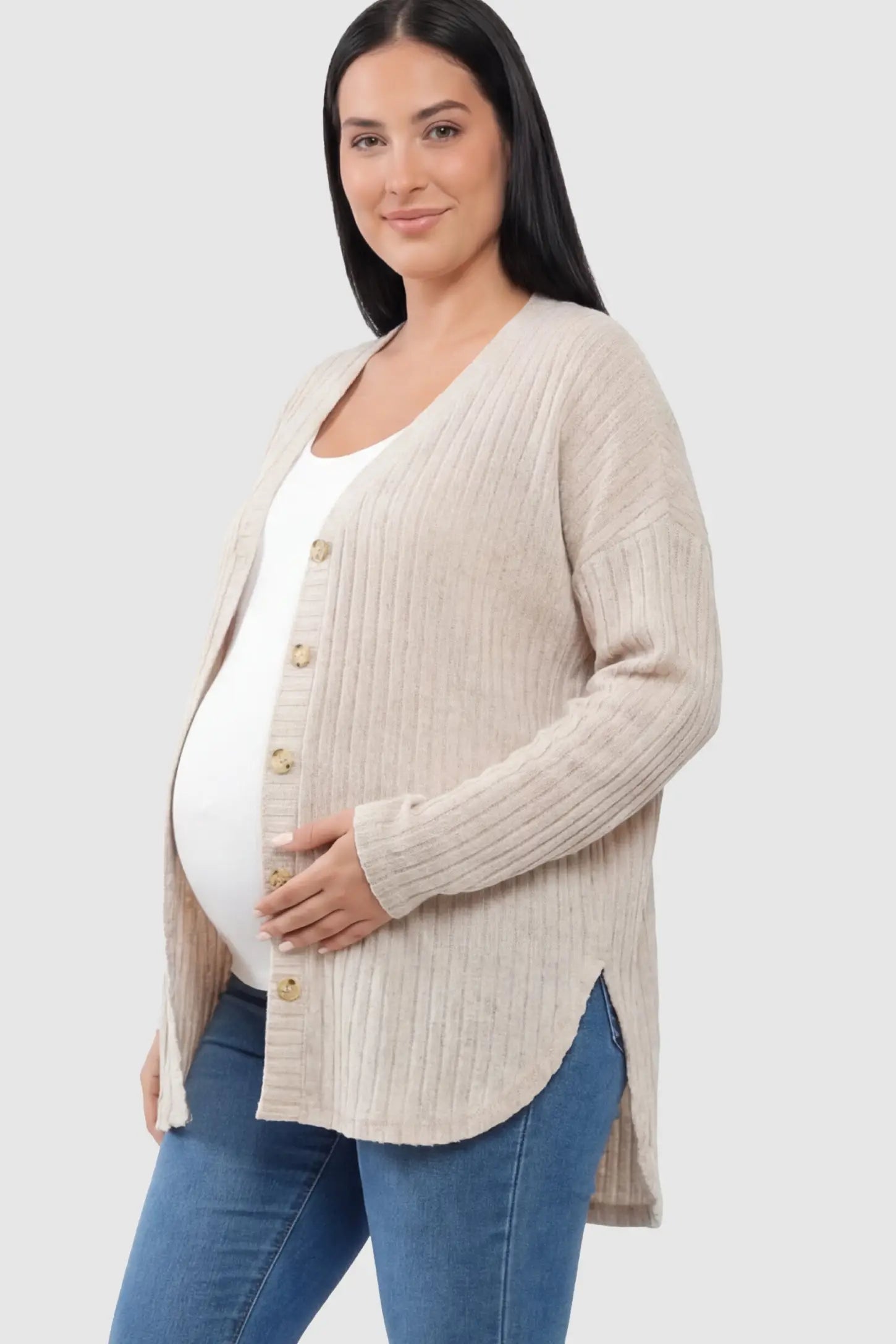 Button Down Ribbed Knit Maternity Cardigan Button Down Ribbed Knit Maternity Cardigan in Khaki featuring a curved high-low hem on a pregnant model.