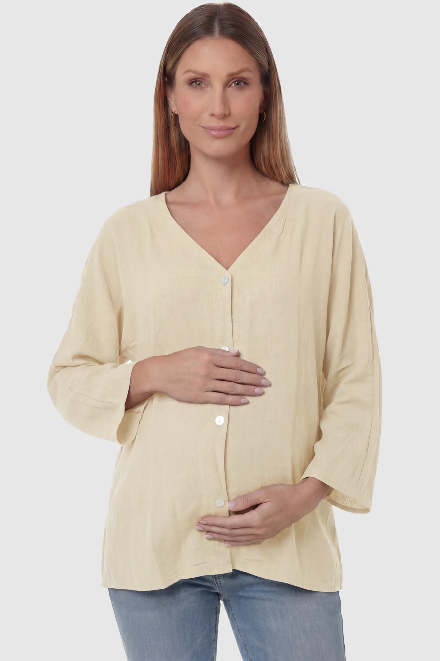 Button Down V-Neck Long Sleeve Maternity Top Button Down V-Neck Long Sleeve Maternity Top in Beige featuring a relaxed drape on a pregnant model, front view.