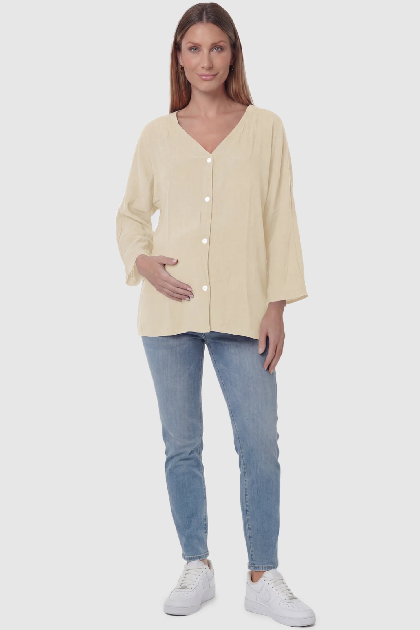 Button Down V-Neck Long Sleeve Maternity Top Button Down V-Neck Long Sleeve Maternity Top in Beige featuring a relaxed drape on a pregnant model, full body view.