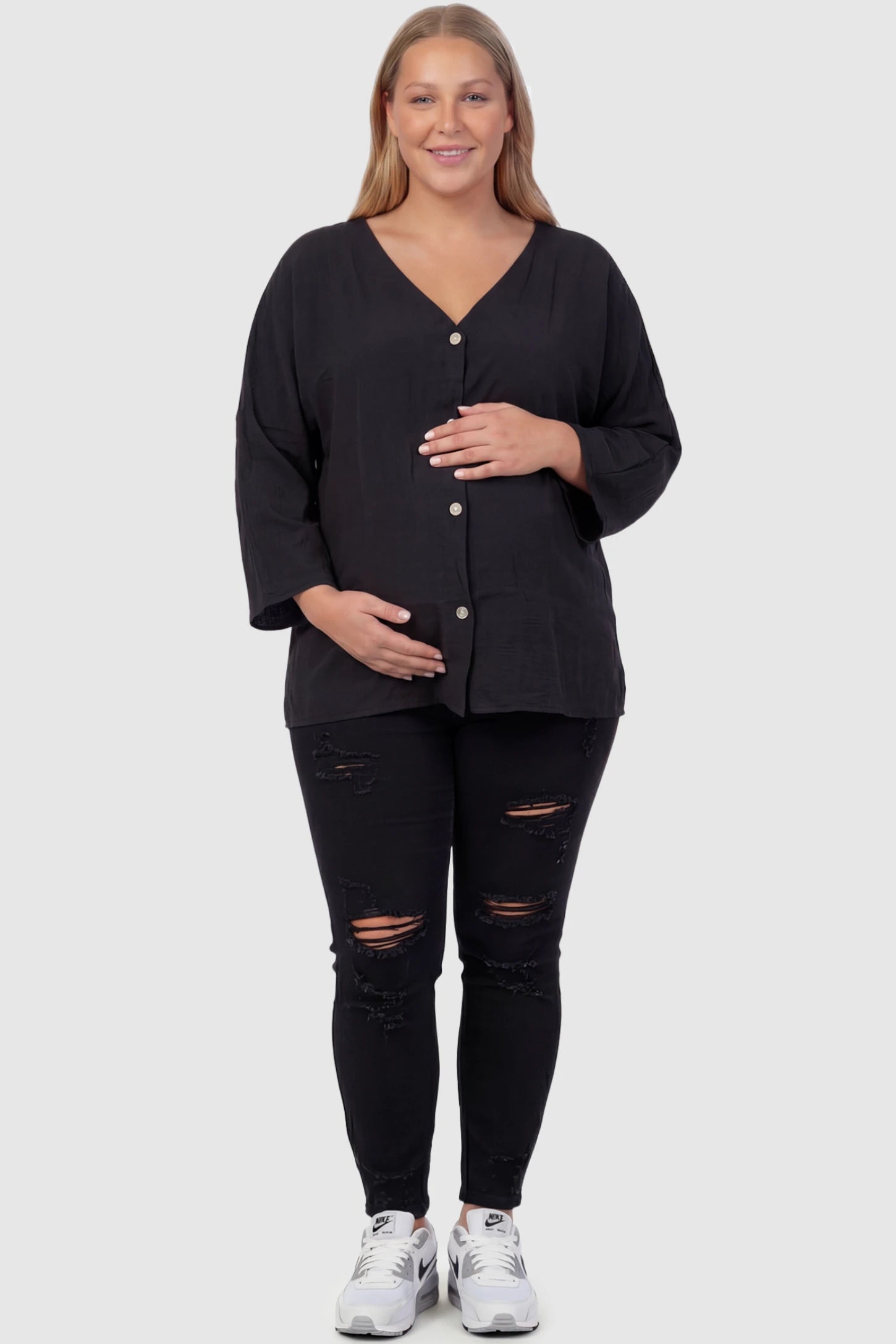 Button Down V-Neck Long Sleeve Maternity Top Button Down V-Neck Long Sleeve Maternity Top in Black featuring a relaxed drape on a plus size pregnant model, front view.