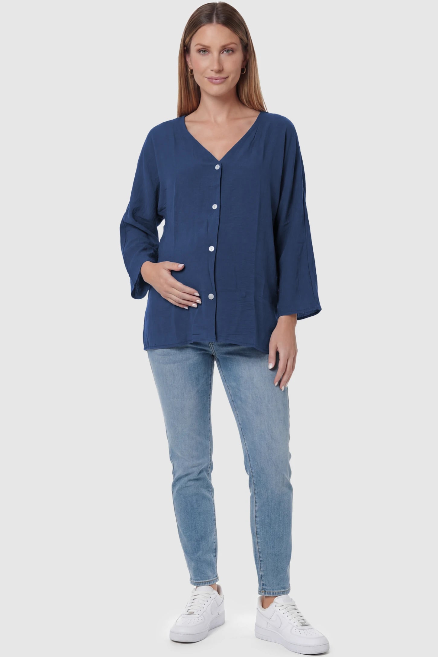 Button Down V-Neck Long Sleeve Maternity Top Button Down V-Neck Long Sleeve Maternity Top in Blue featuring a relaxed drape on a pregnant model, full body view.