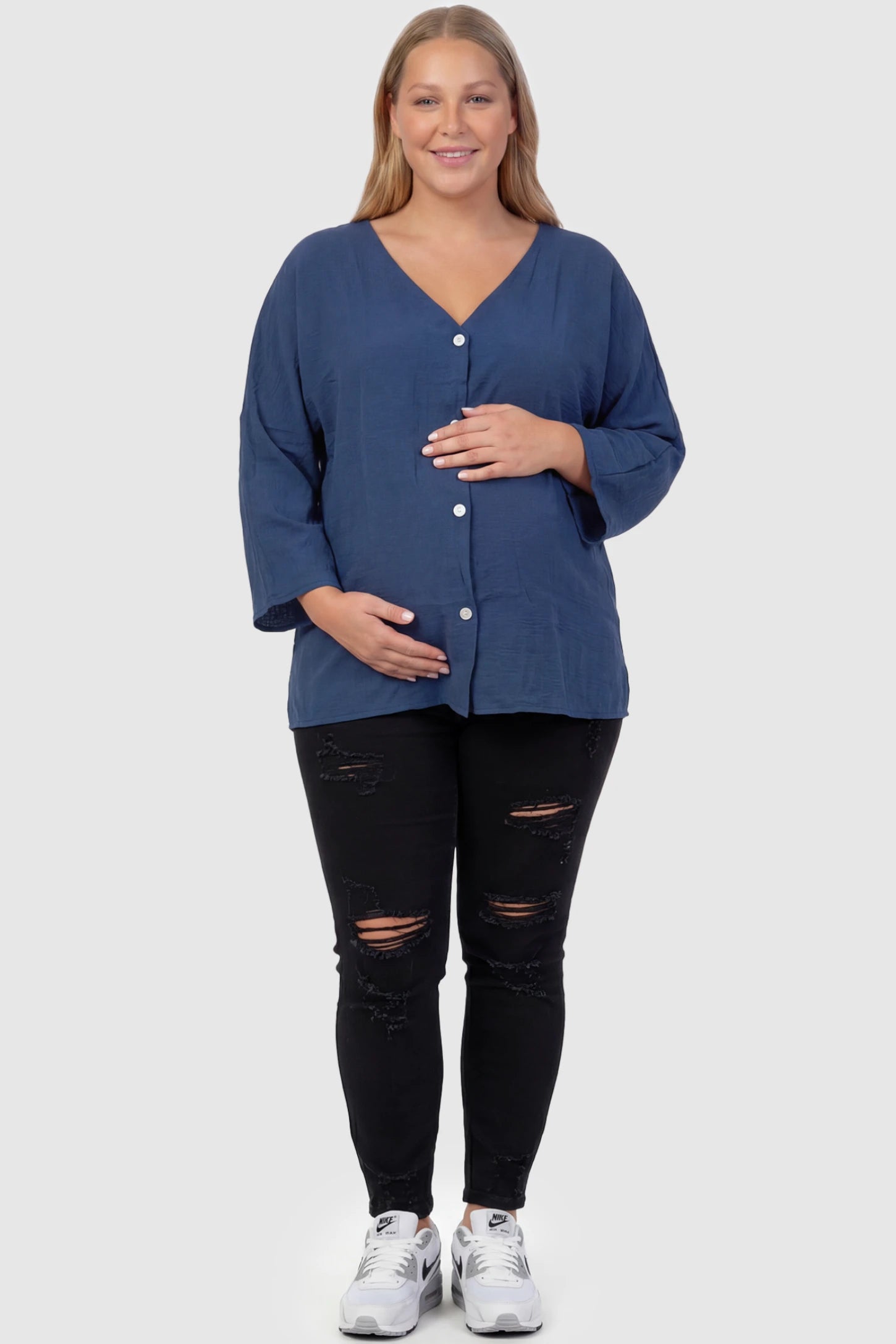 Button Down V-Neck Long Sleeve Maternity Top Button Down V-Neck Long Sleeve Maternity Top in Blue featuring a relaxed drape on a plus size pregnant model, front view.