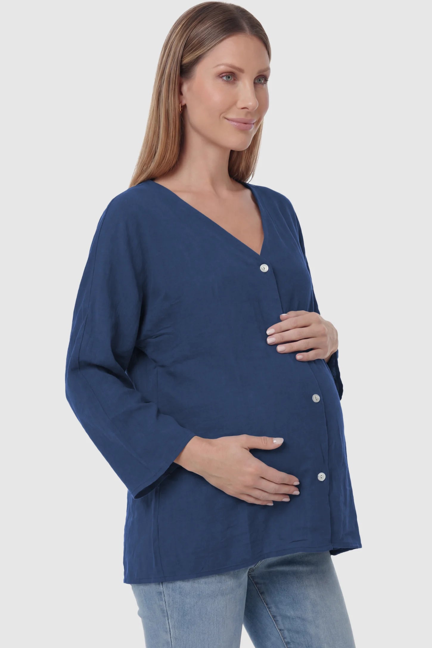 Button Down V-Neck Long Sleeve Maternity Top Button Down V-Neck Long Sleeve Maternity Top in Blue featuring a relaxed drape on a pregnant model, side view.
