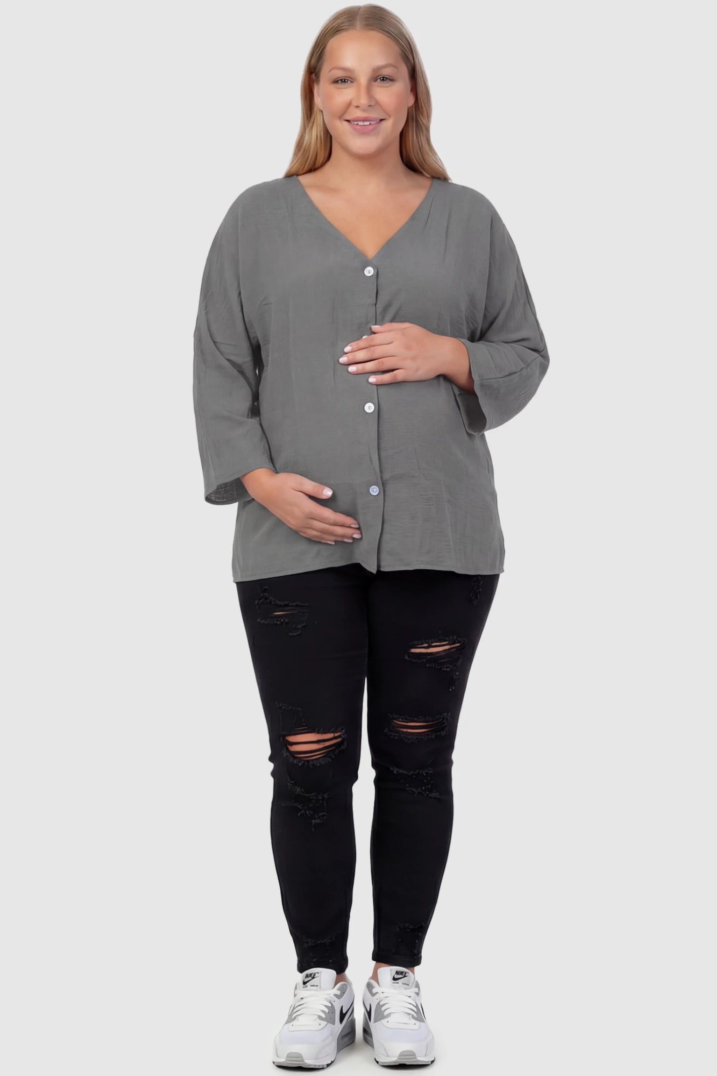 Button Down V-Neck Long Sleeve Maternity Top Button Down V-Neck Long Sleeve Maternity Top in Gray featuring a relaxed drape on a plus size pregnant model, front view.