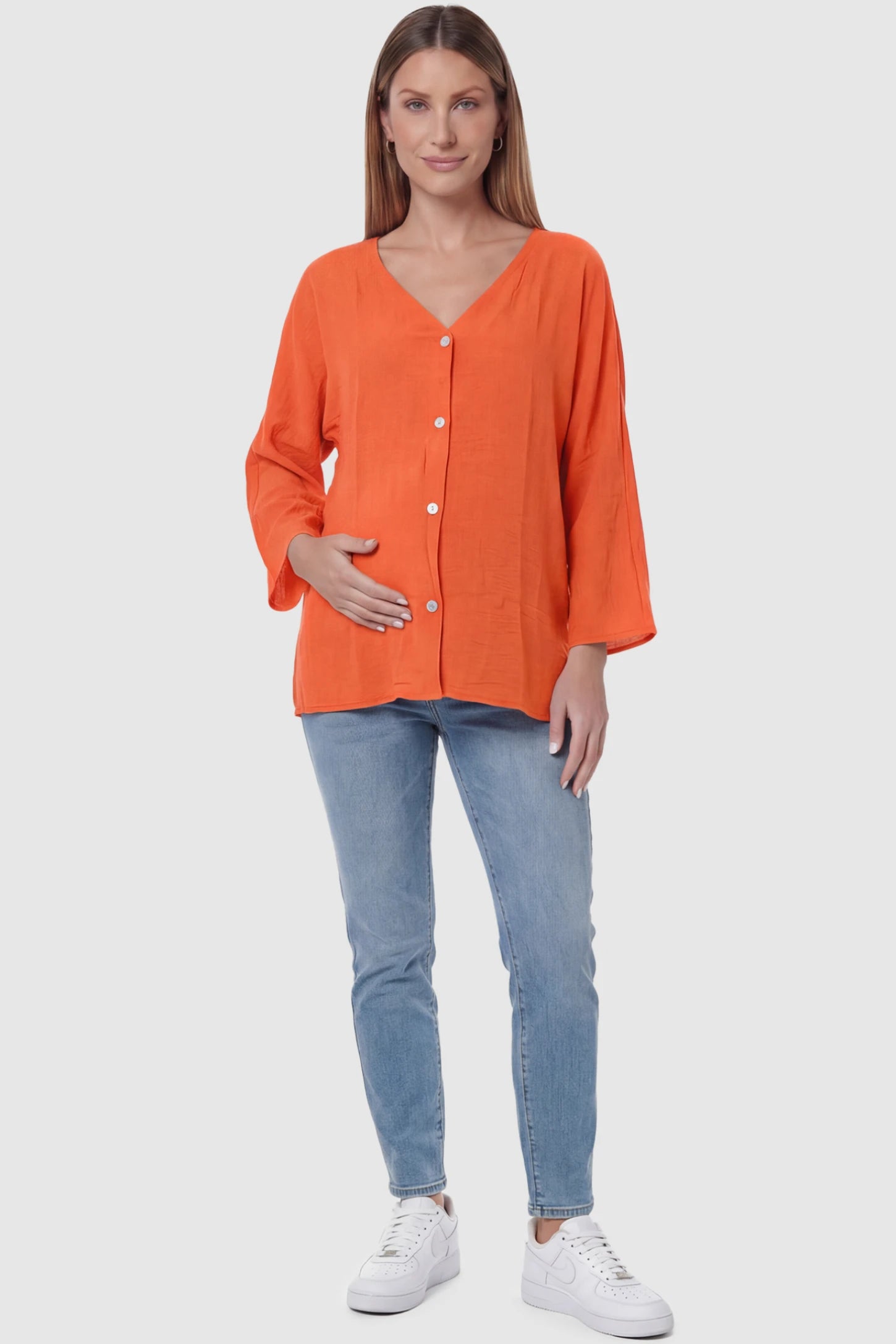 Button Down V-Neck Long Sleeve Maternity Top Button Down V-Neck Long Sleeve Maternity Top in Orange featuring a relaxed drape on a pregnant model, full body view.