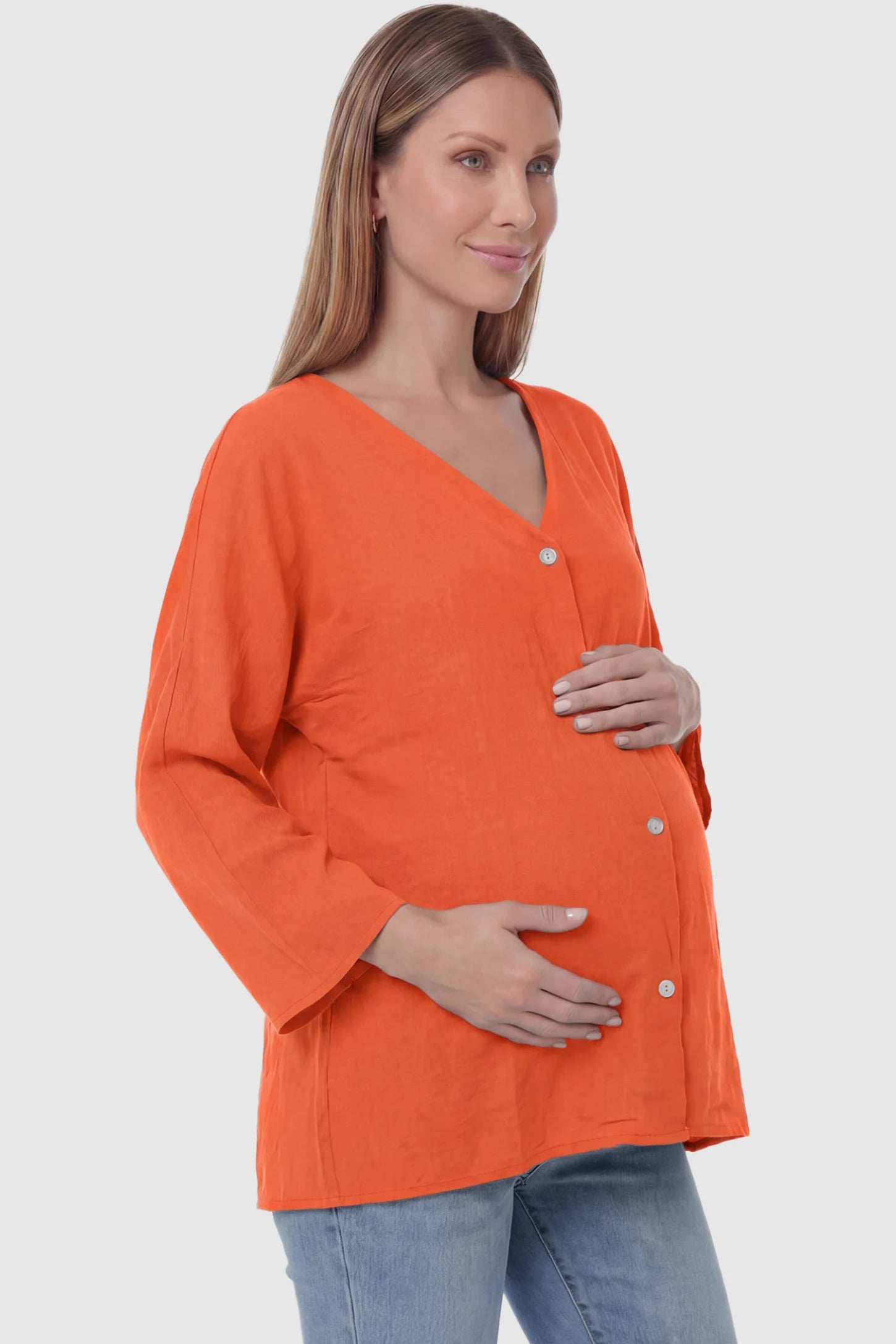Button Down V-Neck Long Sleeve Maternity Top in Orange featuring a relaxed drape on a pregnant model, side view.