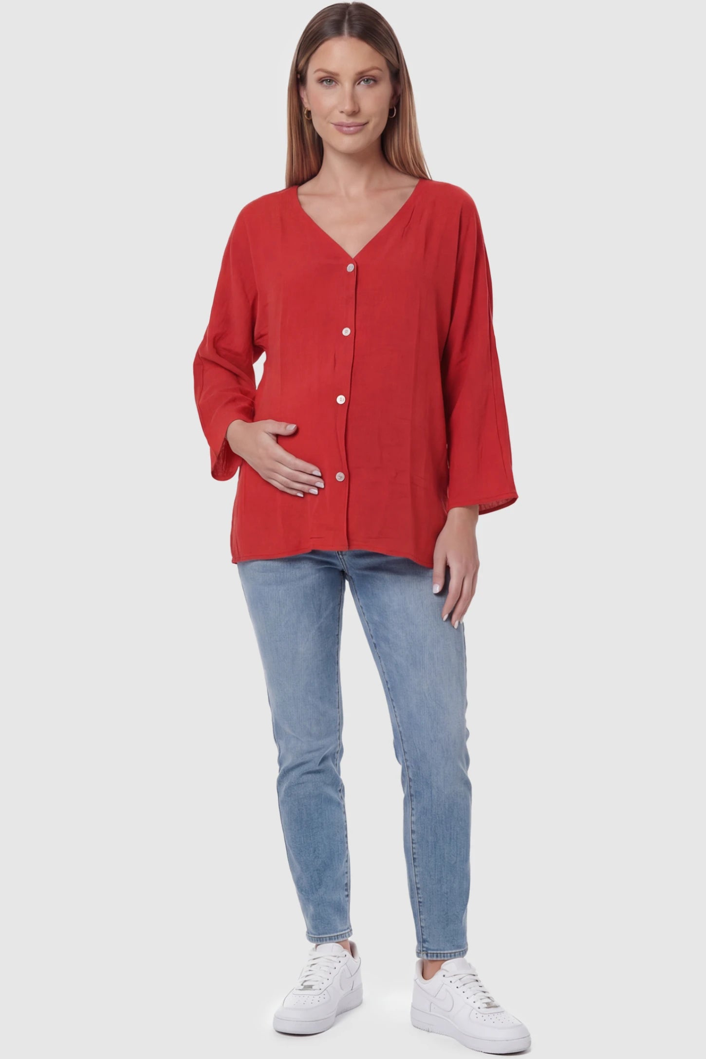 Button Down V-Neck Long Sleeve Maternity Top Button Down V-Neck Long Sleeve Maternity Top in Red featuring a relaxed drape on a pregnant model, full body view.