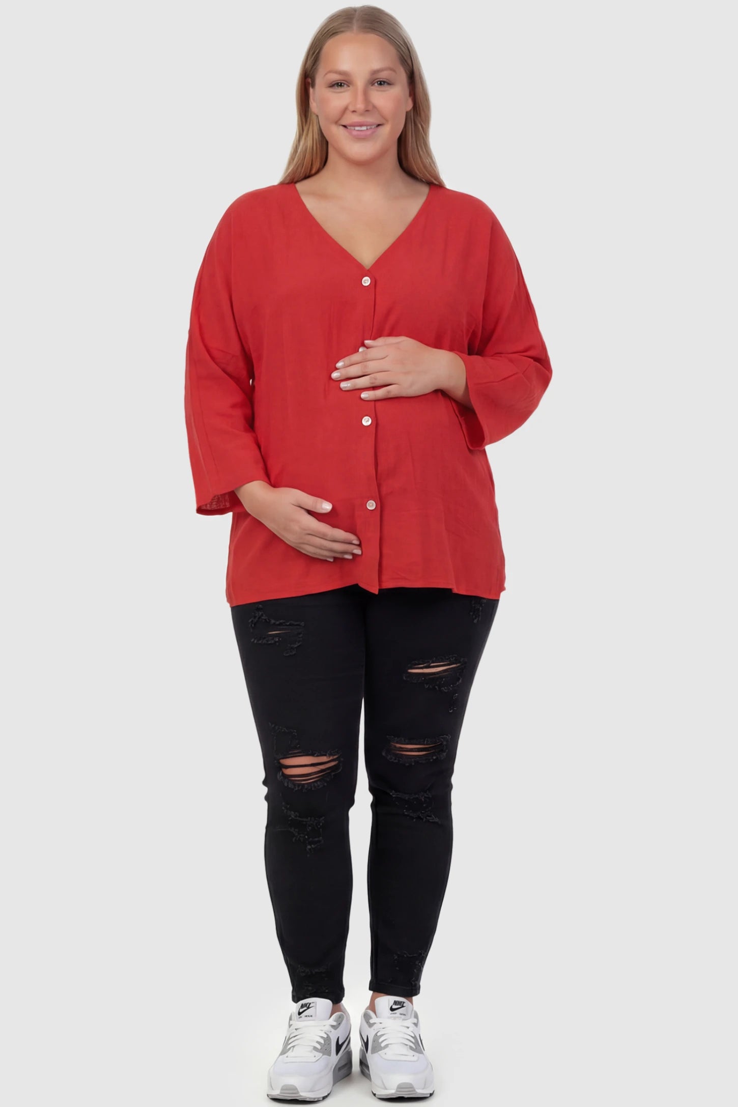 Button Down V-Neck Long Sleeve Maternity Top Button Down V-Neck Long Sleeve Maternity Top in Red featuring a relaxed drape on a plus size pregnant model, front view.