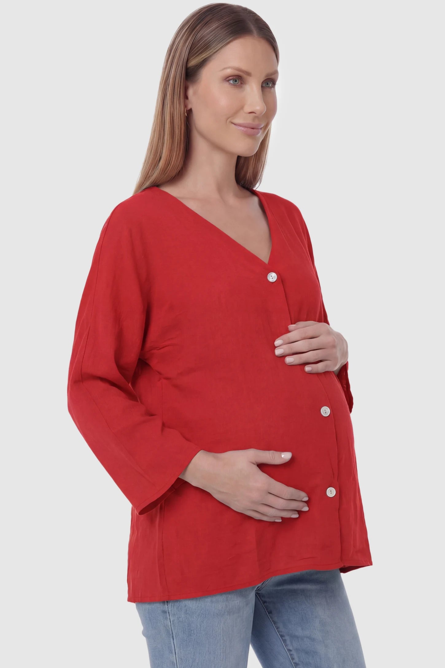 Button Down V-Neck Long Sleeve Maternity Top Button Down V-Neck Long Sleeve Maternity Top in Red featuring a relaxed drape on a pregnant model, side view.