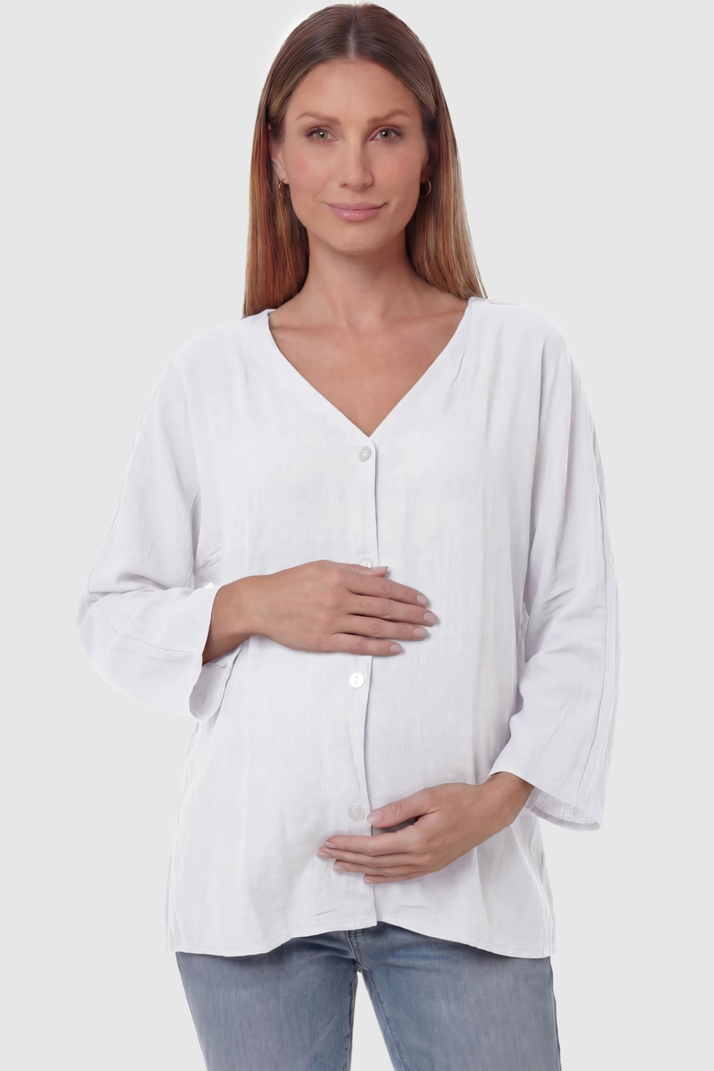 Button Down V-Neck Long Sleeve Maternity Top Button Down V-Neck Long Sleeve Maternity Top in White featuring a relaxed drape on a pregnant model, front view.
