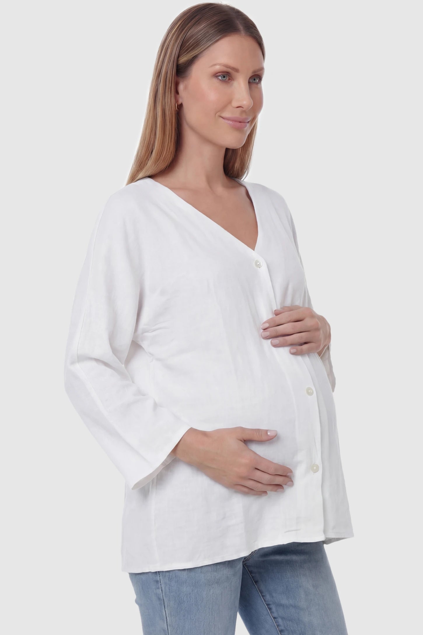 Button Down V-Neck Long Sleeve Maternity Top Button Down V-Neck Long Sleeve Maternity Top in White featuring a relaxed drape on a pregnant model, side view.