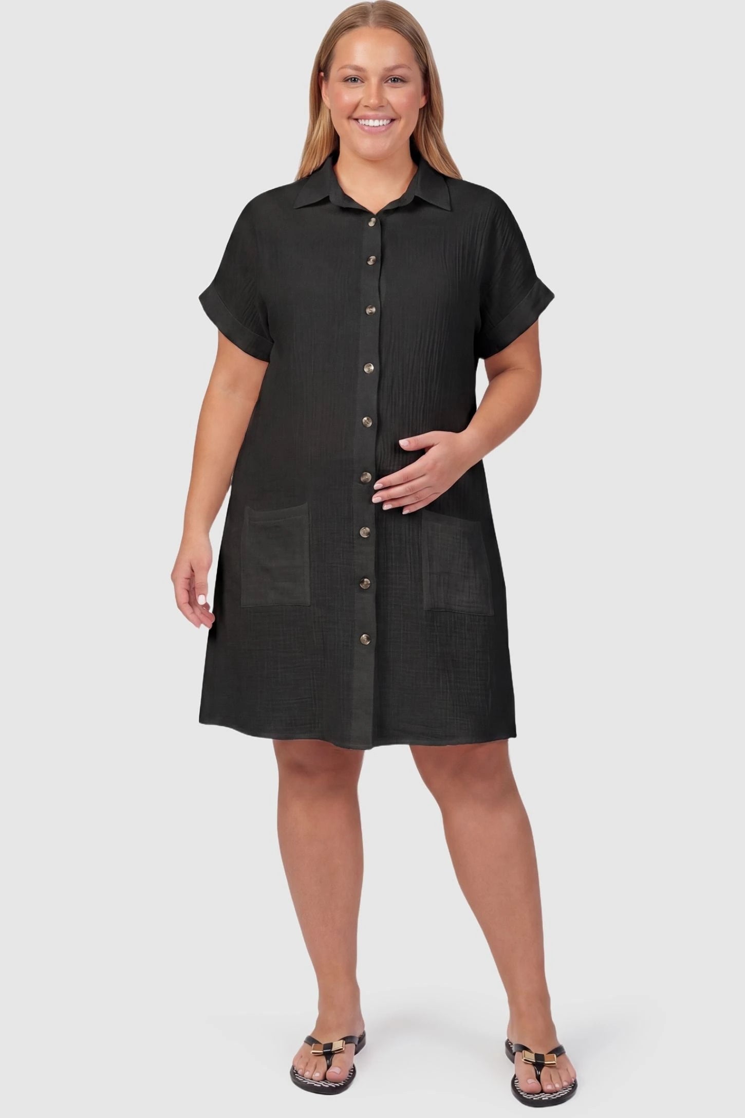 Breezy Button-Front Collared Nursing Dress Breezy Button-Front Collared Nursing Dress in Black featuring cuffed short sleeves on a plus-size pregnant model.