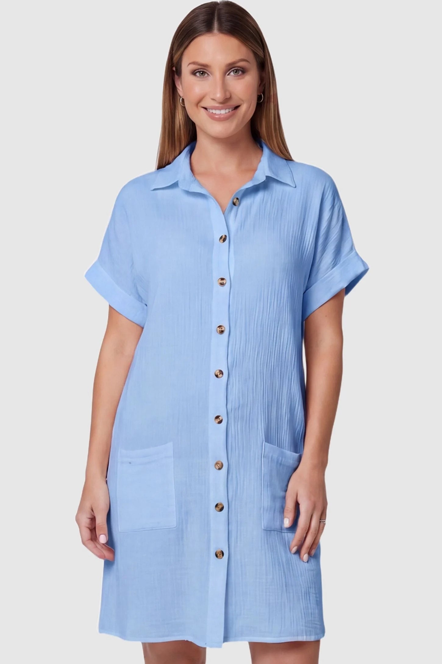 Breezy Button-Front Collared Nursing Dress Breezy Button-Front Collared Nursing Dress in Blue featuring convenient front pockets on a pregnant model, front view.