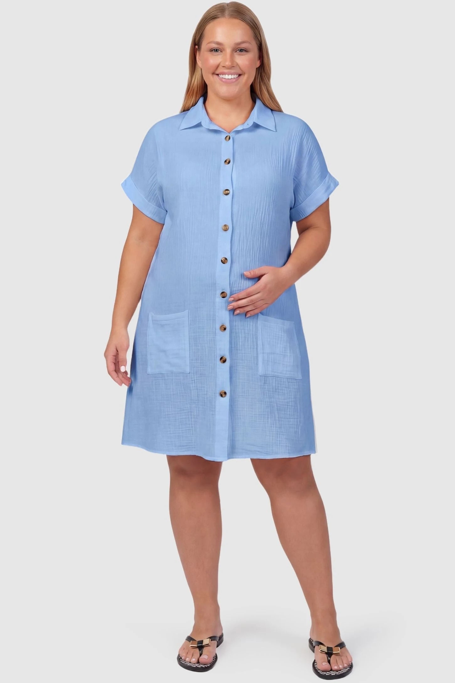 Breezy Button-Front Collared Nursing Dress Breezy Button-Front Collared Nursing Dress in Blue featuring cuffed short sleeves on a plus-size pregnant model.