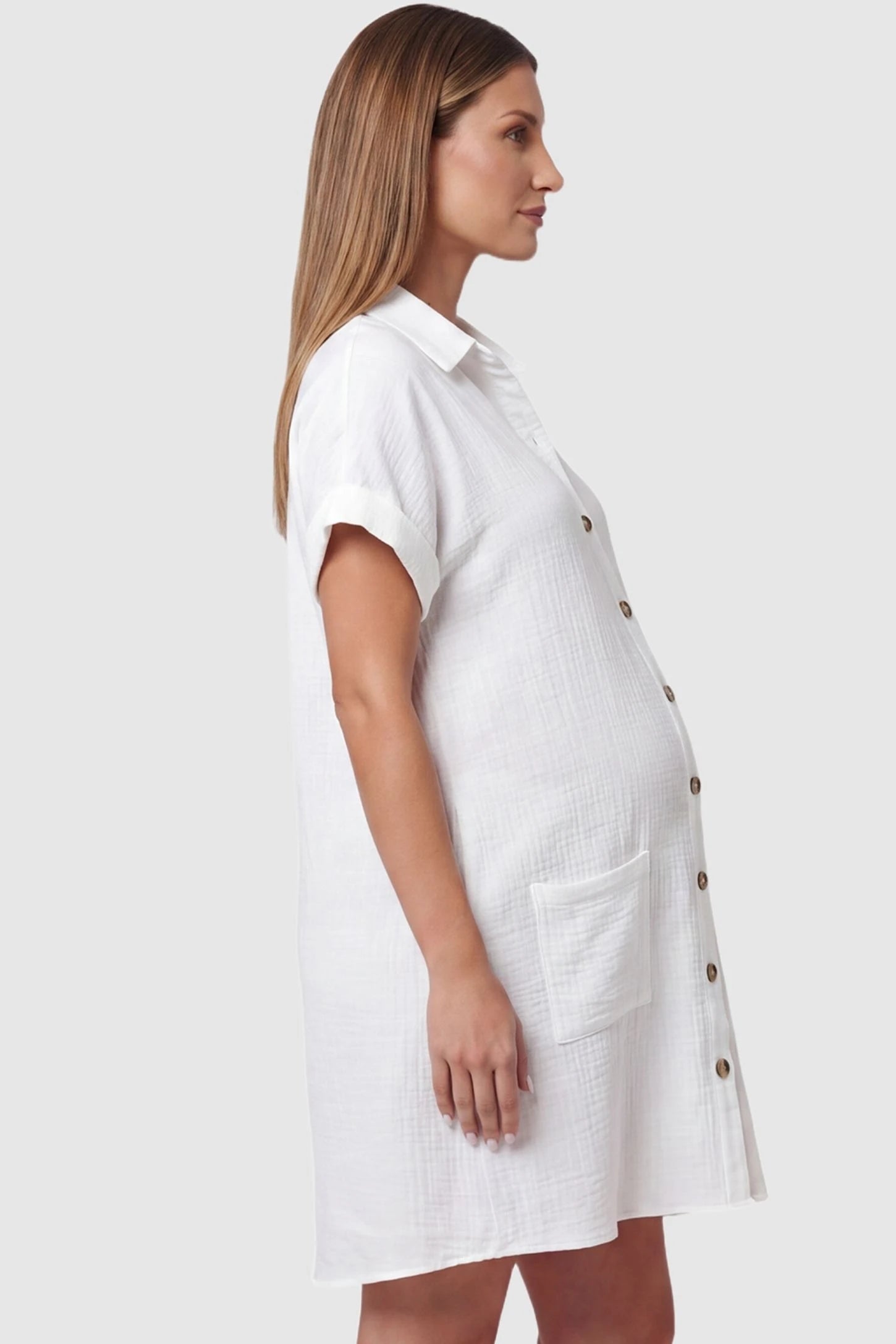 Breezy Button-Front Collared Nursing Dress Side view of White Breezy Button-Front Collared Nursing Dress featuring a relaxed fit on a pregnant model.