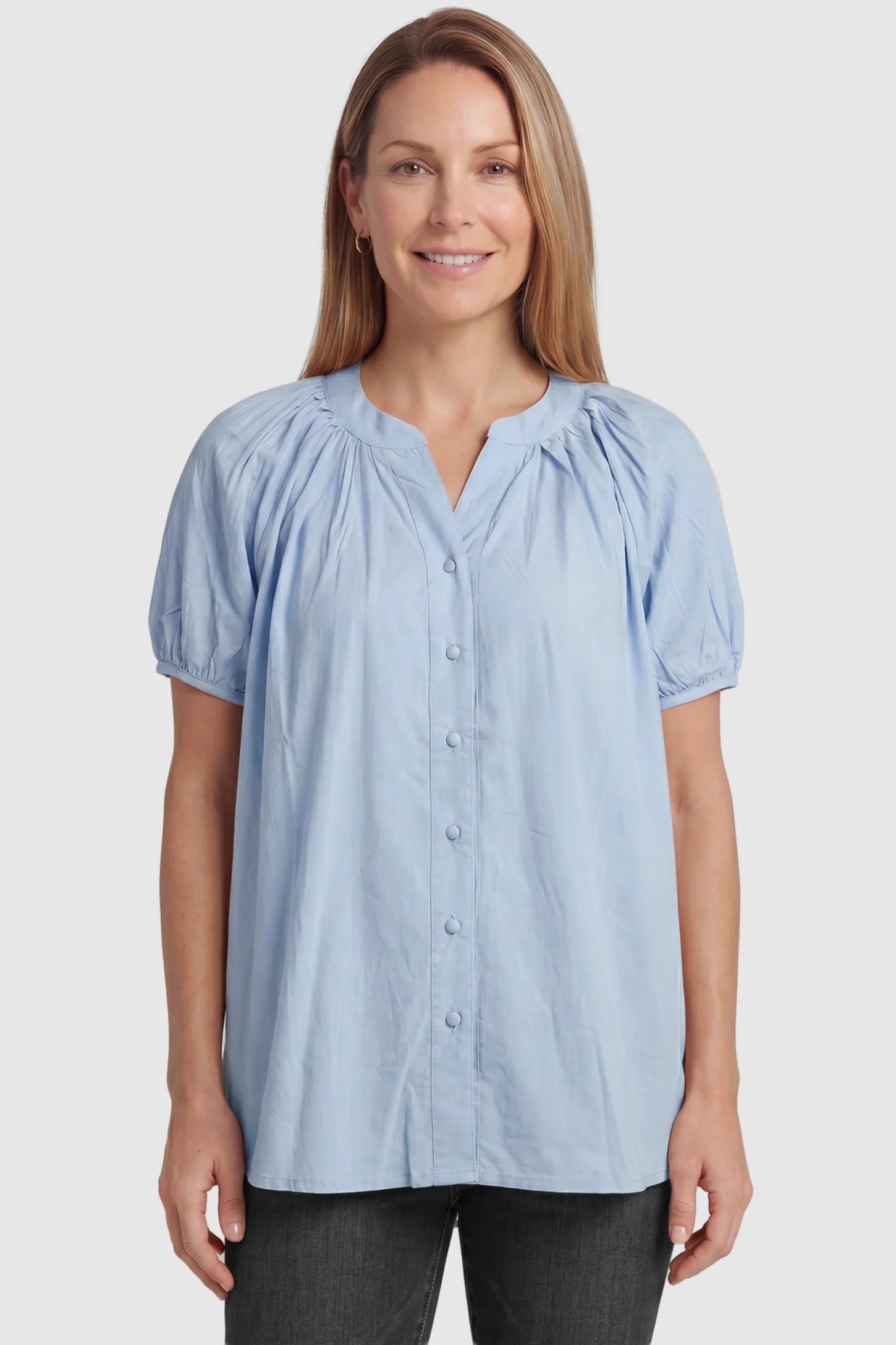 Button Front Short Sleeve Maternity Blouse Button Front Short Sleeve Maternity Blouse in Blue featuring gathered fabric and a button-up neck on a postpartum model, front view.