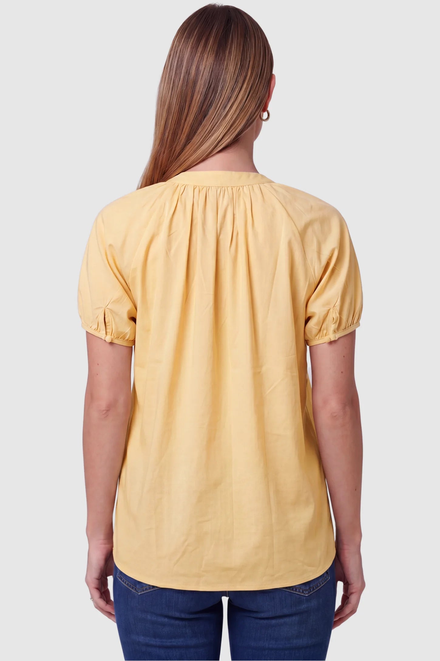 Button Front Short Sleeve Maternity Blouse Button Front Short Sleeve Maternity Blouse in Yellow featuring gathered fabric and short sleeves on a pregnant model, back view.