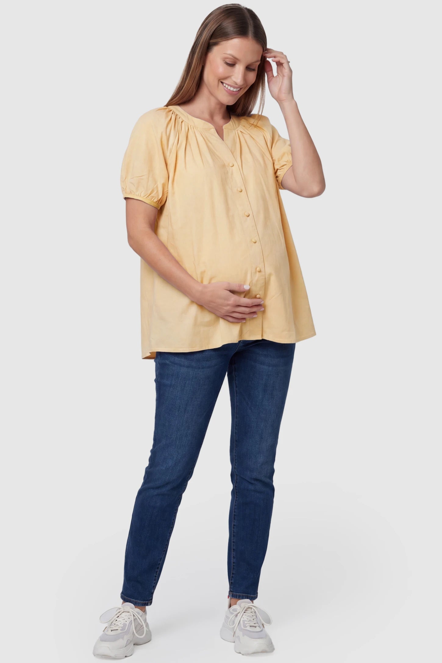Button Front Short Sleeve Maternity Blouse Button Front Short Sleeve Maternity Blouse in Yellow featuring gathered fabric and a button-up neck on a pregnant model, full body view.
