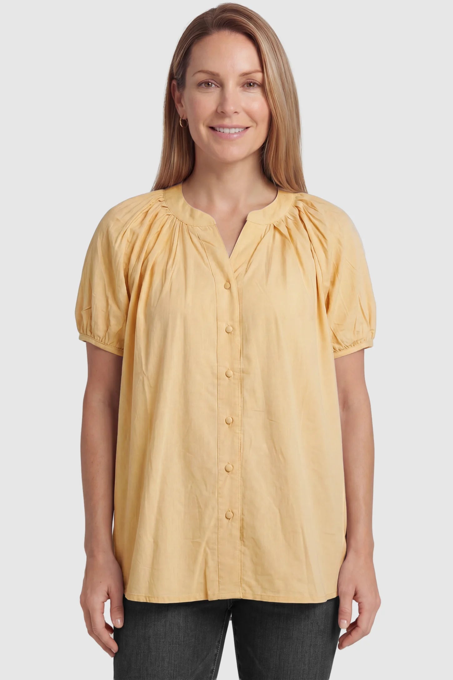 Button Front Short Sleeve Maternity Blouse Button Front Short Sleeve Maternity Blouse in Yellow featuring gathered fabric and a button-up neck on a postpartum model, front view.