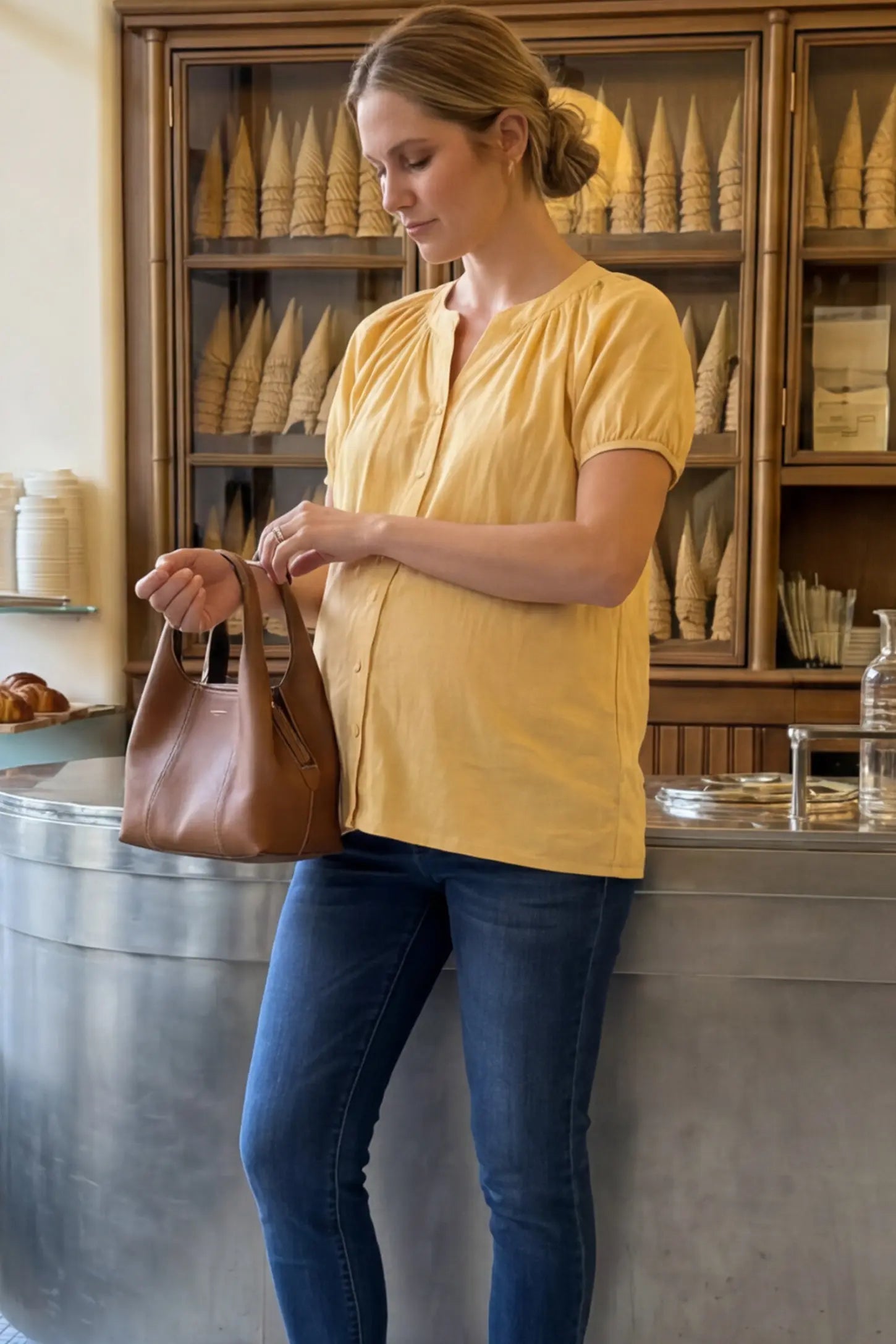 Button Front Short Sleeve Maternity Blouse Button Front Short Sleeve Maternity Blouse in Yellow featuring gathered fabric and a button-up neck on a pregnant woman in indoor setting, side view.