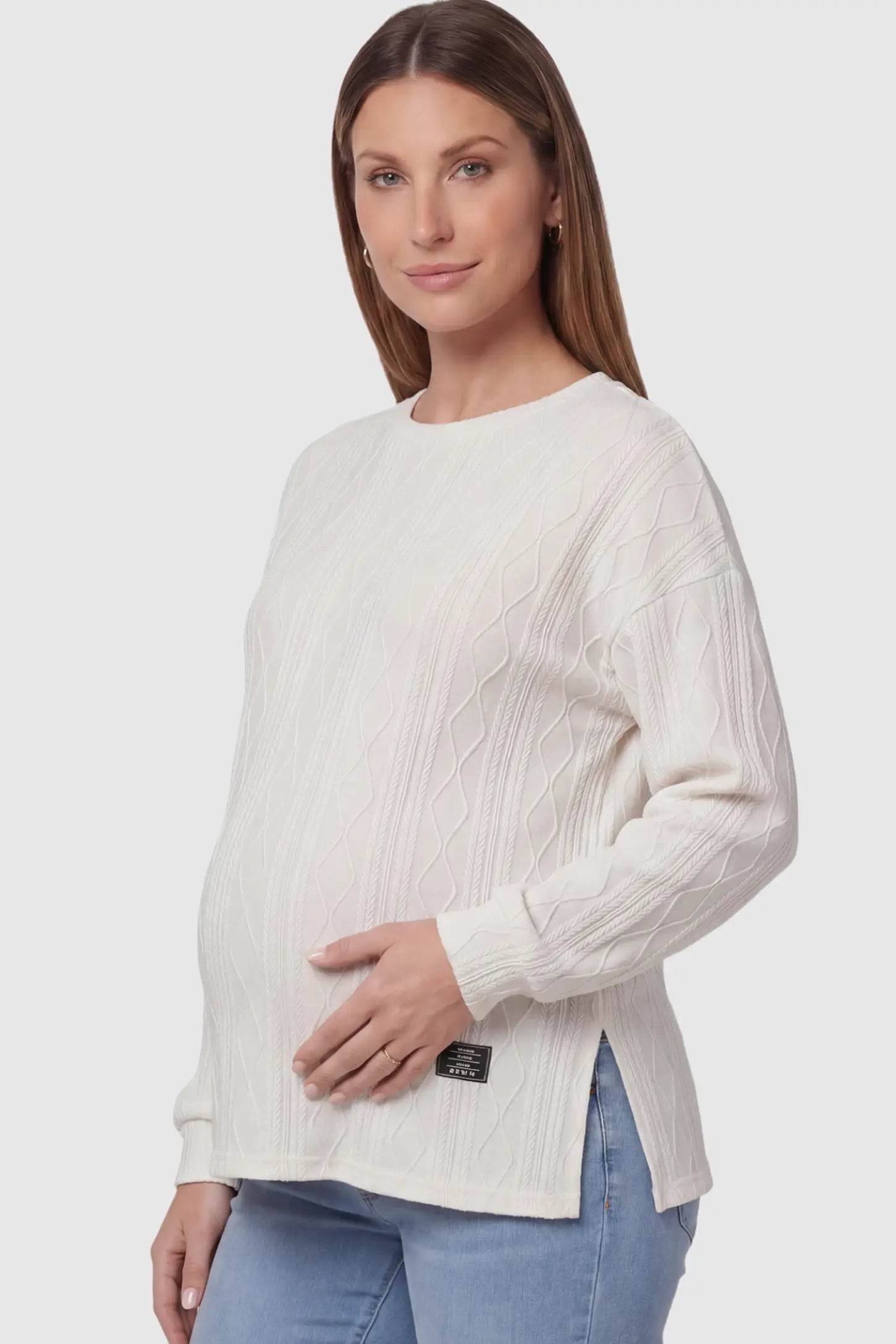 Cable Knit Long Sleeve Maternity Sweater in Apricot on a pregnant model.