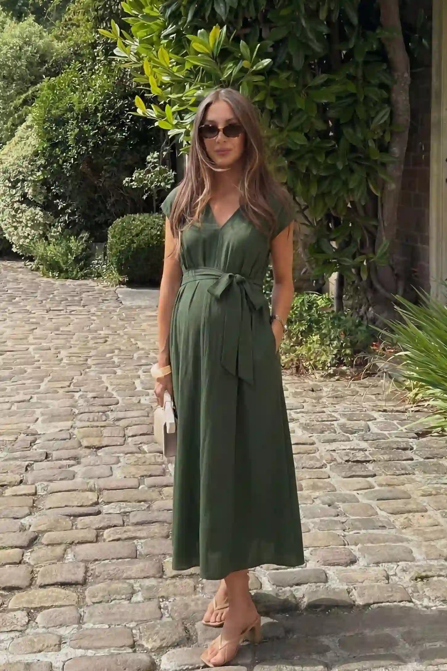 Cap Sleeves Belted Maternity Midi Dress Cap Sleeves Belted Midi Dress in Army Green featuring a tie waist on a pregnant model, editorial lifestyle.