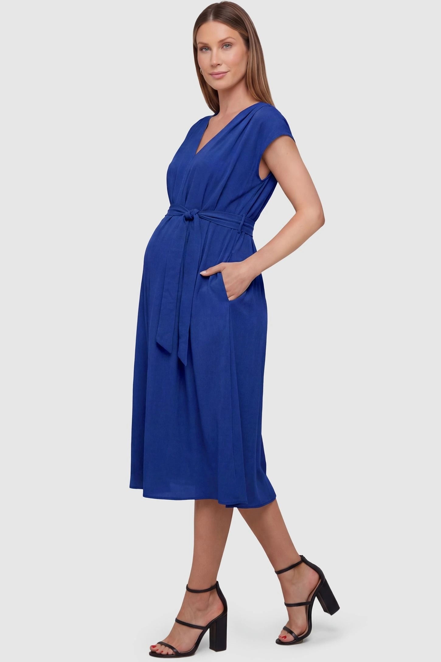 Cap Sleeves Belted Maternity Midi Dress Cap Sleeves Belted Midi Dress in Blue featuring a tie waist on a pregnant model, side view.