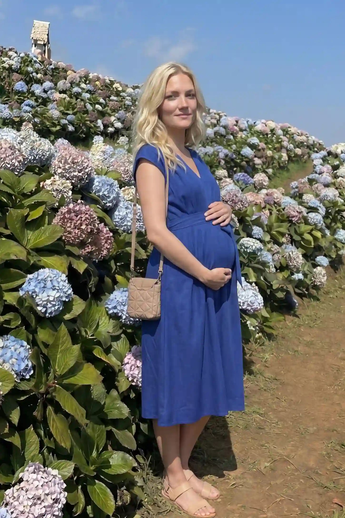 Cap Sleeves Belted Maternity Midi Dress  Cap Sleeves Belted Midi Dress in Blue featuring a tie waist on a pregnant model, UGC.