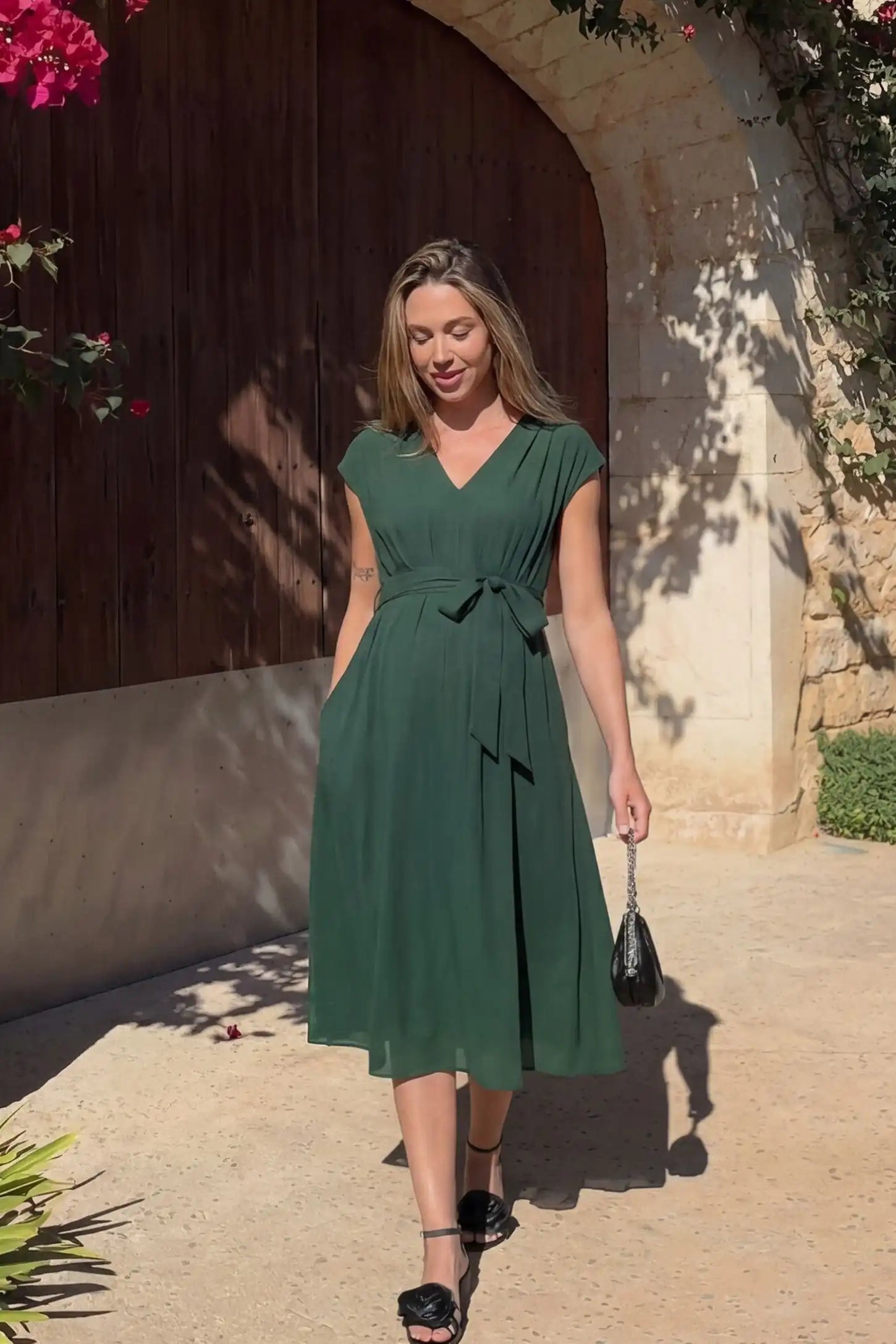 Cap Sleeves Belted Maternity Midi Dress Cap Sleeves Belted Midi Dress in Dark Green featuring a tie waist on a pregnant model, editorial lifestyle.