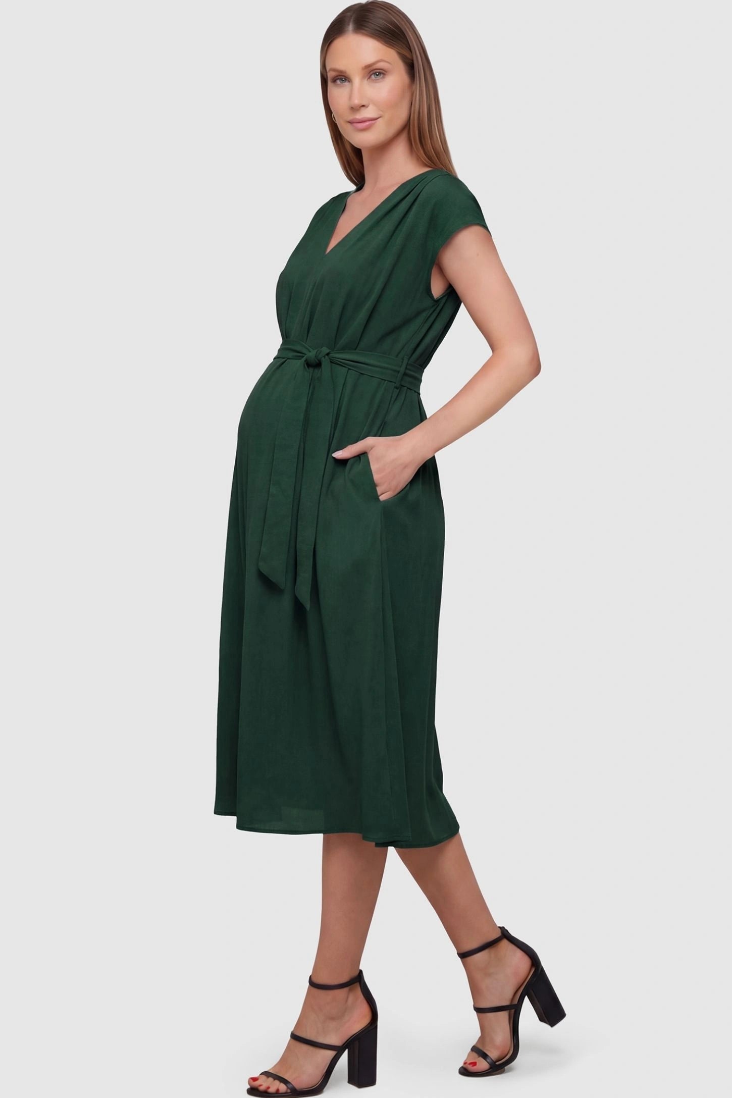 Cap Sleeves Belted Maternity Midi Dress Cap Sleeves Belted Midi Dress in Dark Green featuring a tie waist on a pregnant model, side view.