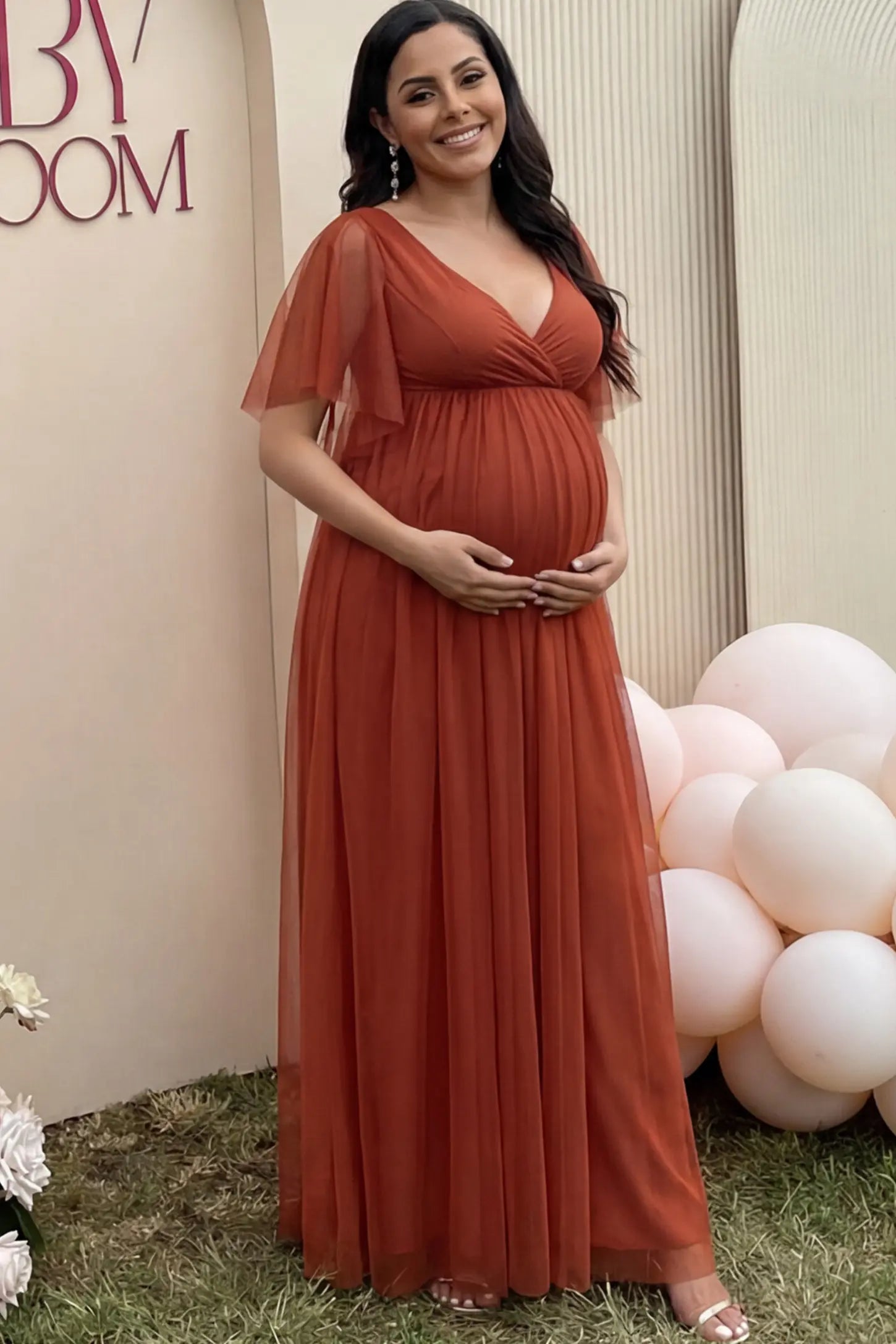 Chiffon Flutter Sleeve V-Neck Maternity Maxi Dress Chiffon Flutter Sleeve V-Neck Maternity Maxi Dress in Rust featuring a mesh overlay on a pregnant woman showing front.