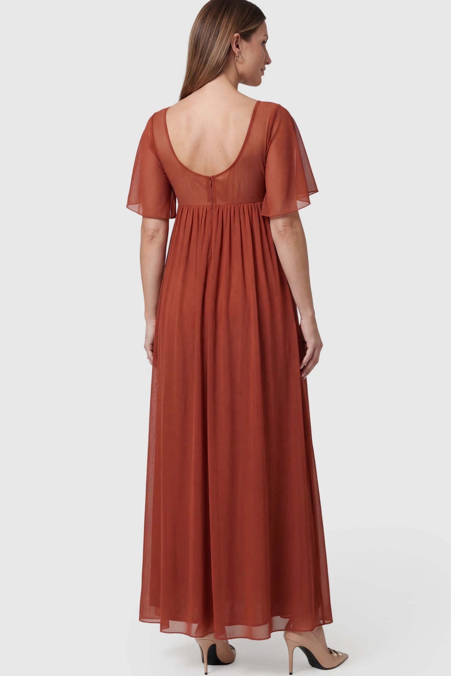 Chiffon Flutter Sleeve V-Neck Maternity Maxi Dress Chiffon Flutter Sleeve V-Neck Maternity Maxi Dress in Rust featuring a mesh overlay on a pregnant model showing back.