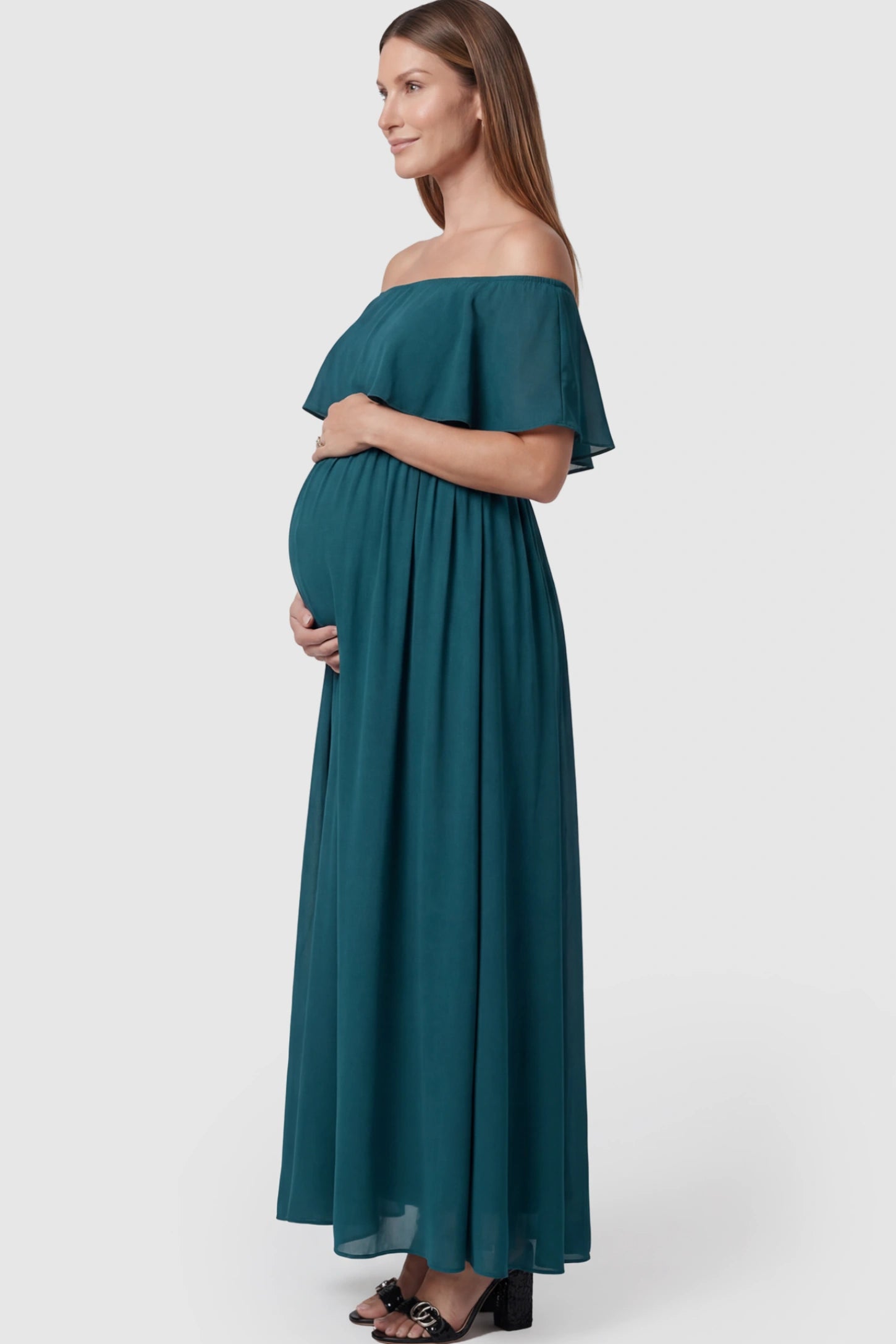Chiffon Off Shoulder Maternity Maxi Dress Chiffon Off-Shoulder Maternity Maxi Dress in green featuring a Floor-length on a pregnant model showing side.