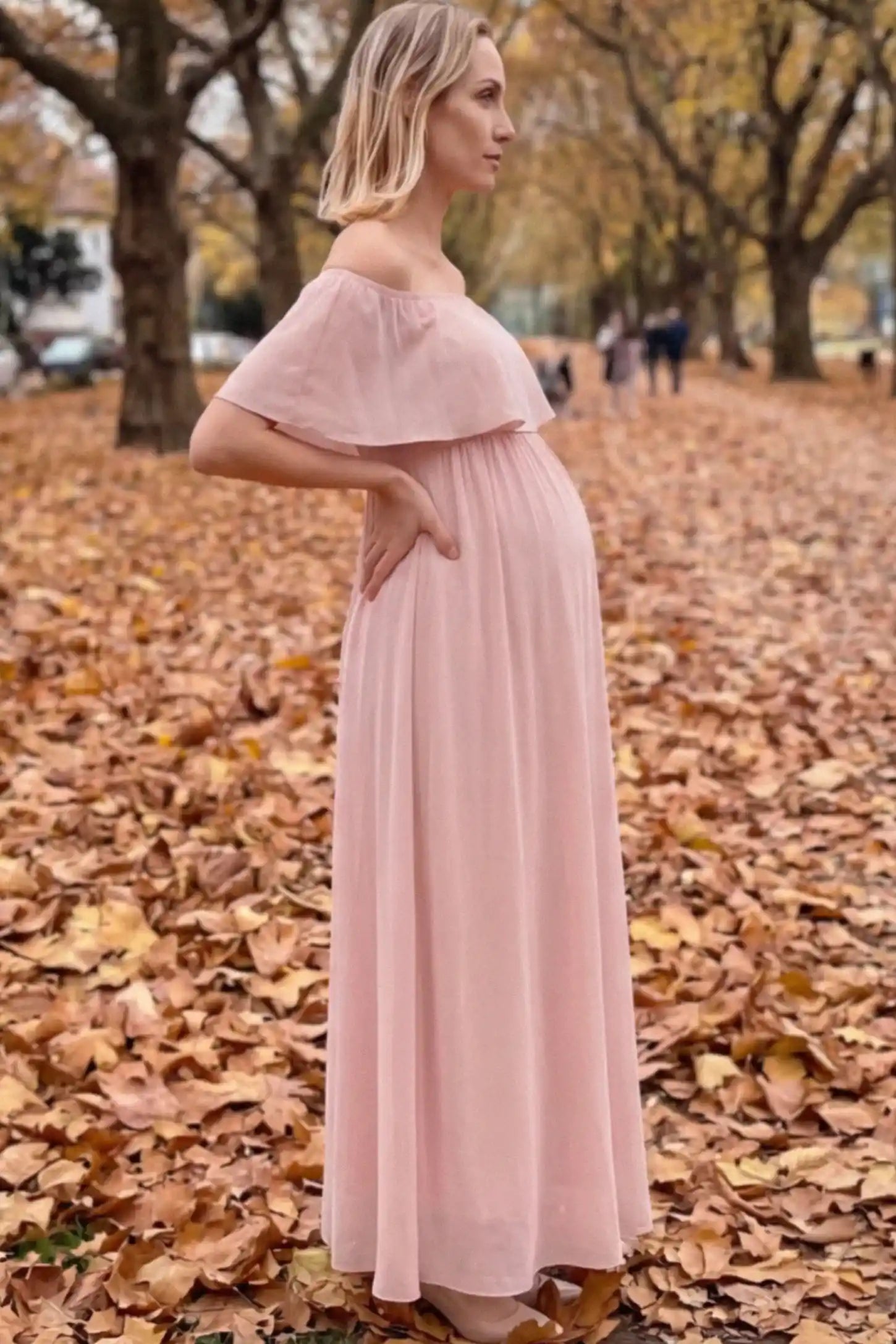 Chiffon Off Shoulder Maternity Maxi Dress Chiffon Off-Shoulder Maternity Maxi Dress in Pink featuring a Floor-length on a pregnant woman showing side.