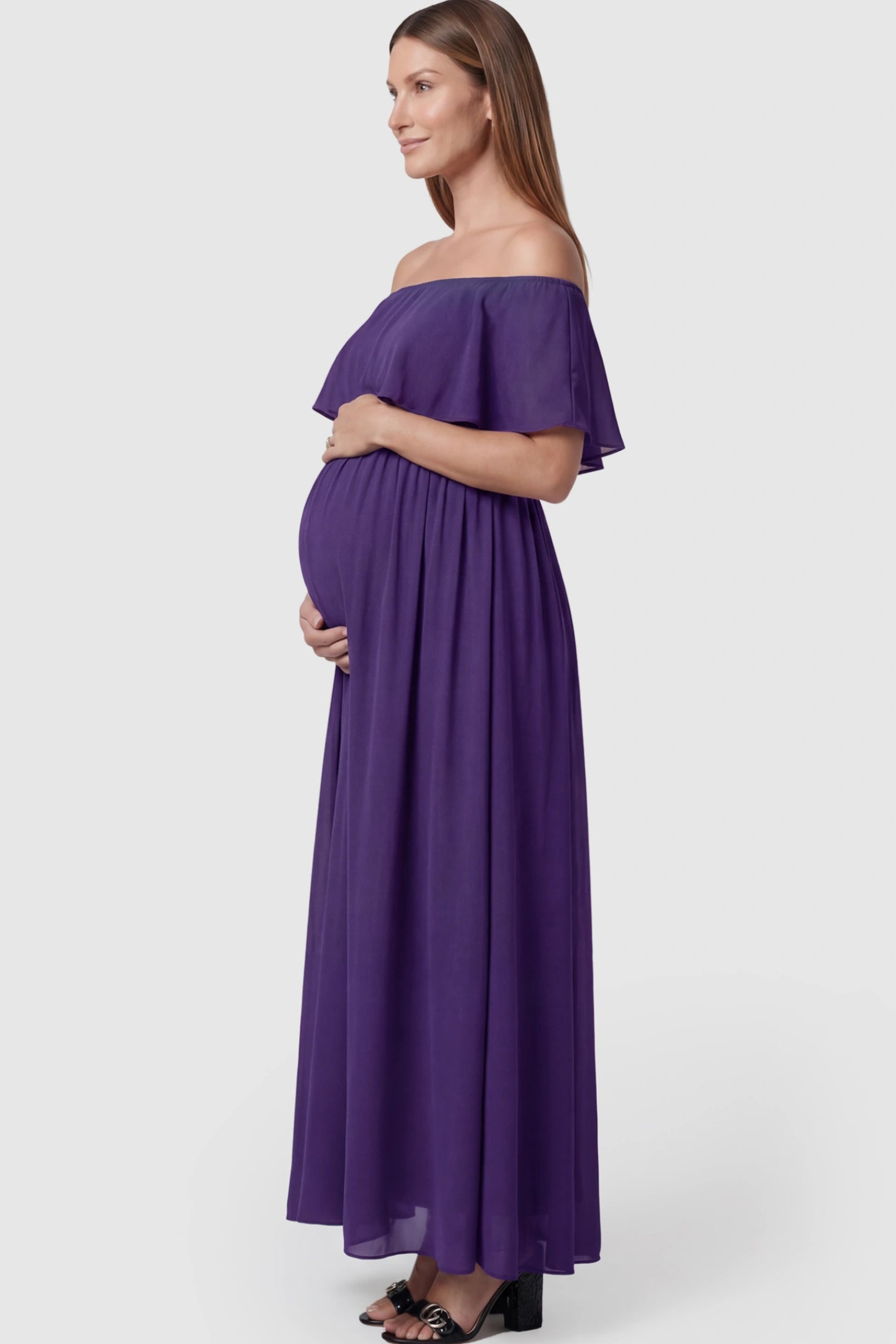 Chiffon Off Shoulder Maternity Maxi Dress Chiffon Off-Shoulder Maternity Maxi Dress in Purple featuring a Floor-length on a pregnant model showing side.