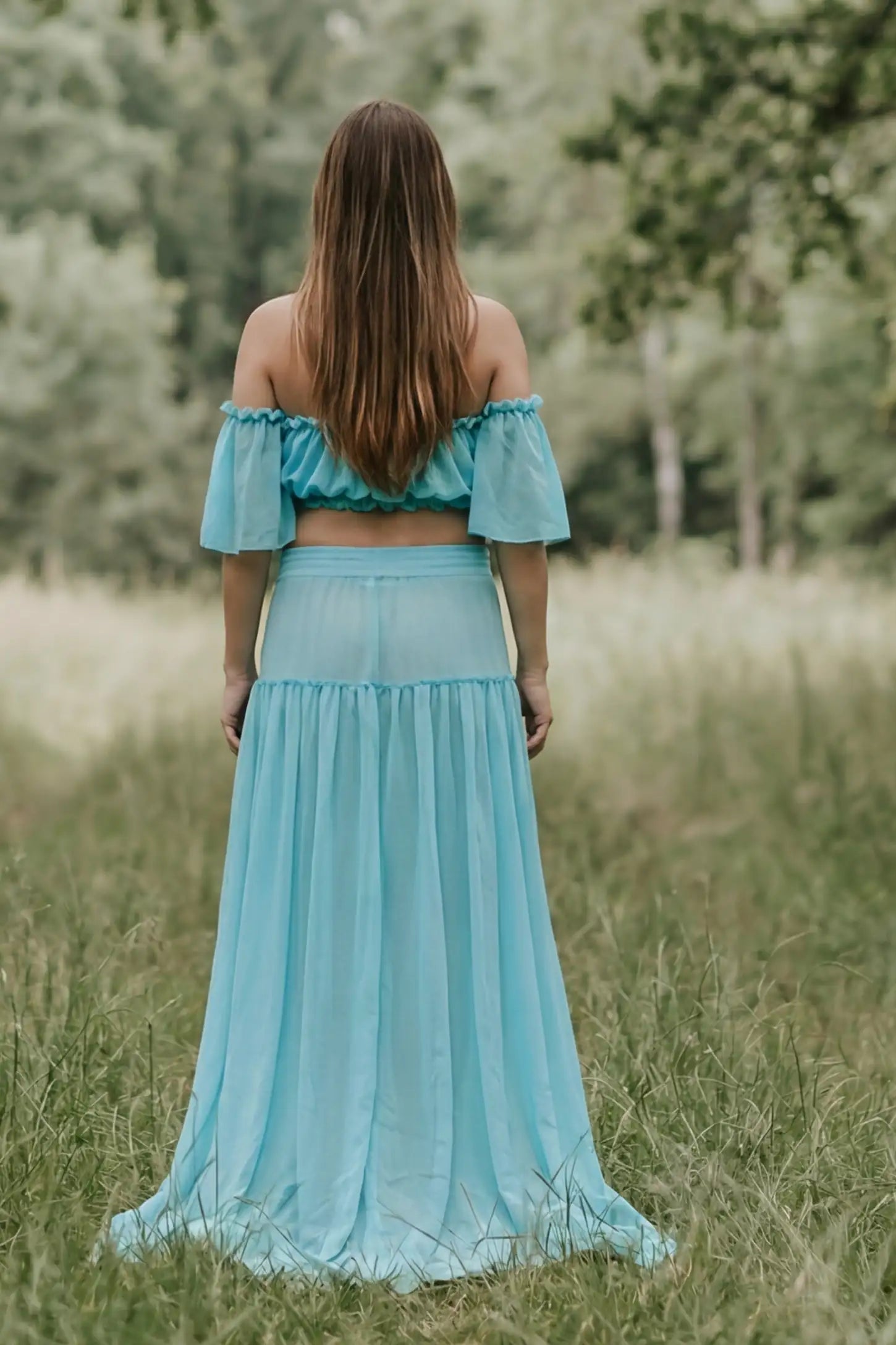 Chiffon Ruffle Off-Shoulder Two-Piece Maxi Maternity Dress Chiffon Ruffle Off-Shoulder Two-Piece Maxi Maternity Dress in Blue featuring a sheer tiered maxi skirt on a non-pregnant model, back view.