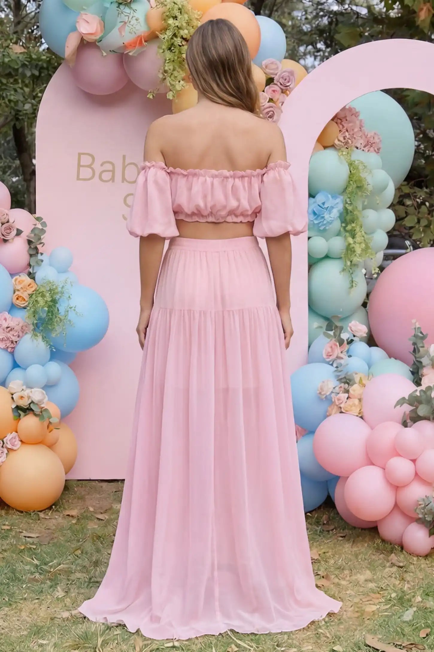 Chiffon Ruffle Off-Shoulder Two-Piece Maxi Maternity Dress Chiffon Ruffle Off-Shoulder Two-Piece Maxi Maternity Dress in Pink featuring a cropped tiered top on a pregnant model, back view.