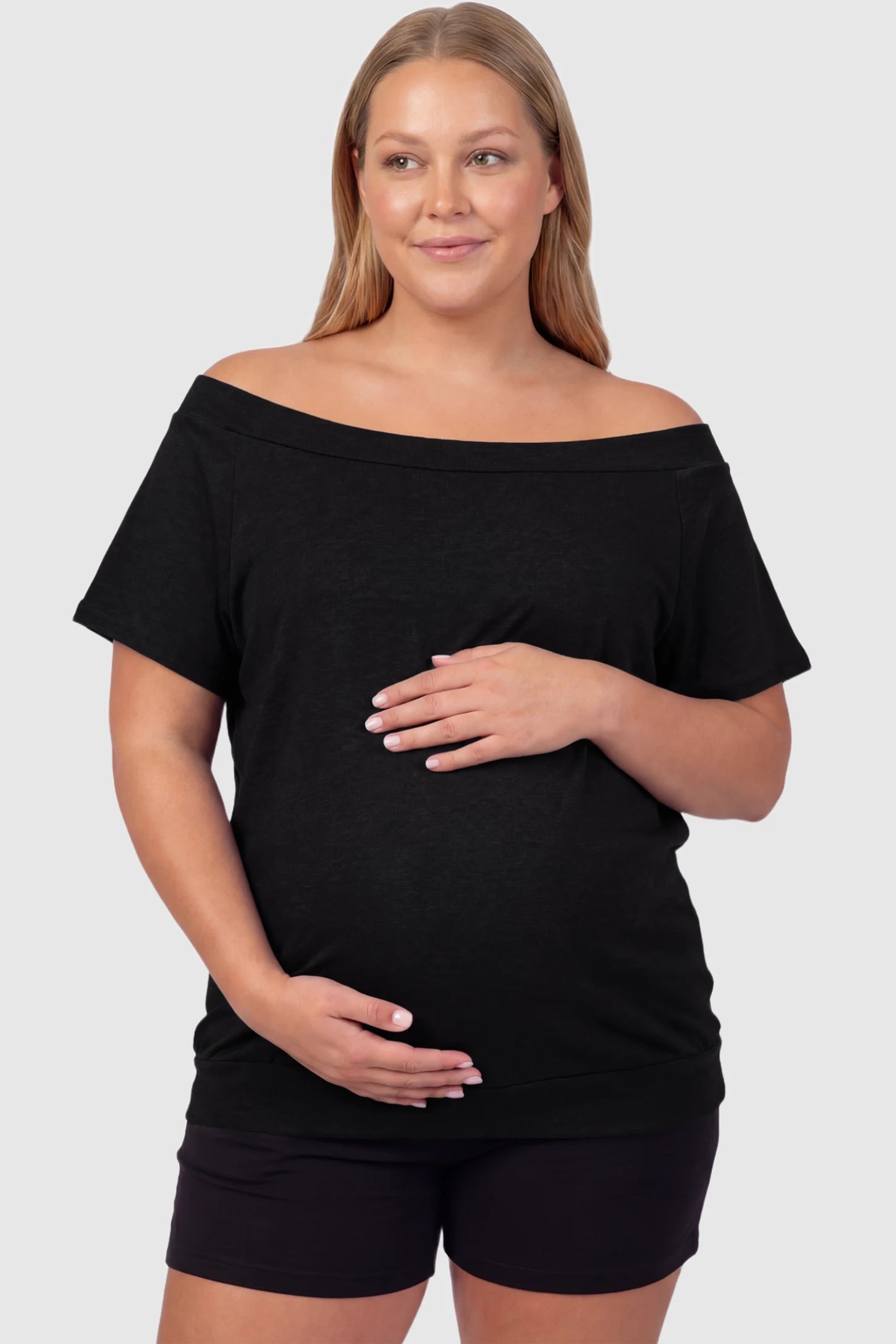 Convertible Neck Short Sleeve Maternity Top Convertible Neck Short Sleeve Maternity Top in black featuring an adjustable neckline and a comfortable banded hem on a plus size pregnant model front view.