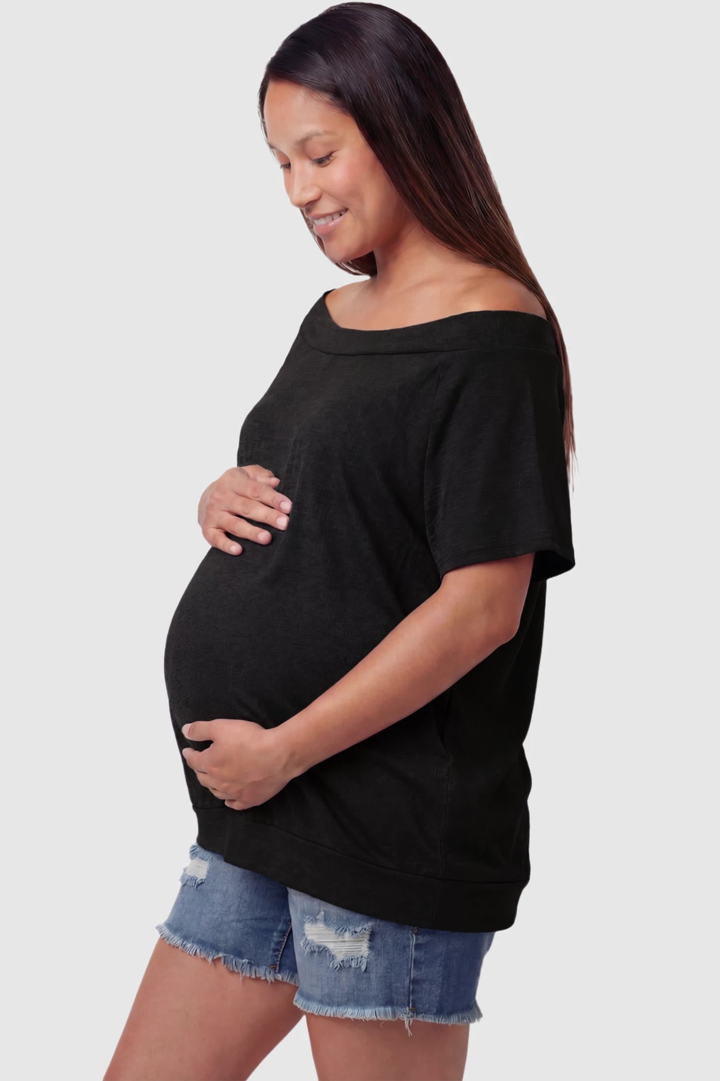 Convertible Neck Short Sleeve Maternity Top Convertible Neck Short Sleeve Maternity Top in black featuring an adjustable neckline and a comfortable banded hem on a pregnant model side view.