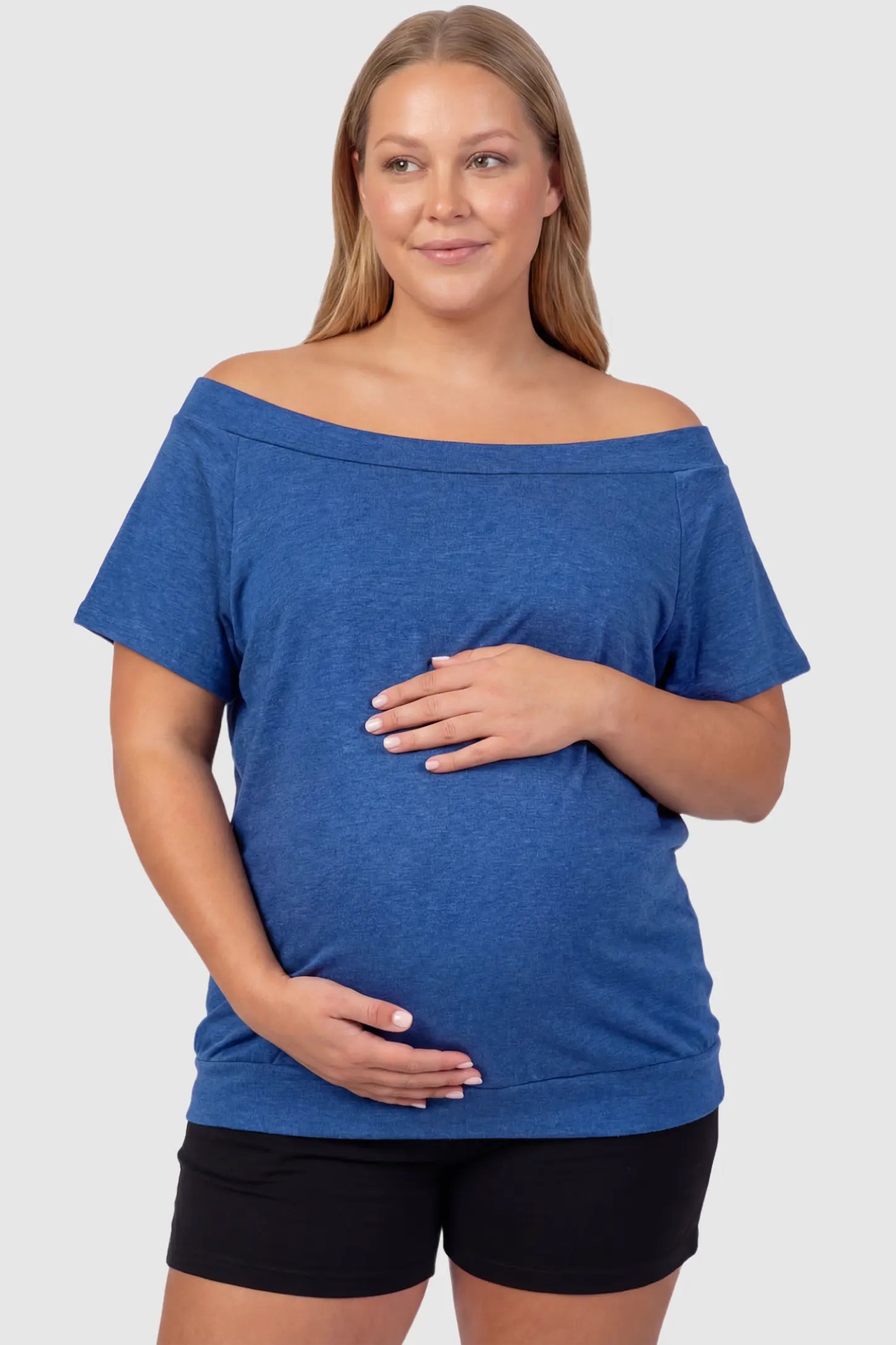 Convertible Neck Short Sleeve Maternity Top Convertible Neck Short Sleeve Maternity Top in blue featuring an adjustable neckline and a comfortable banded hem on a plus size pregnant model front view.