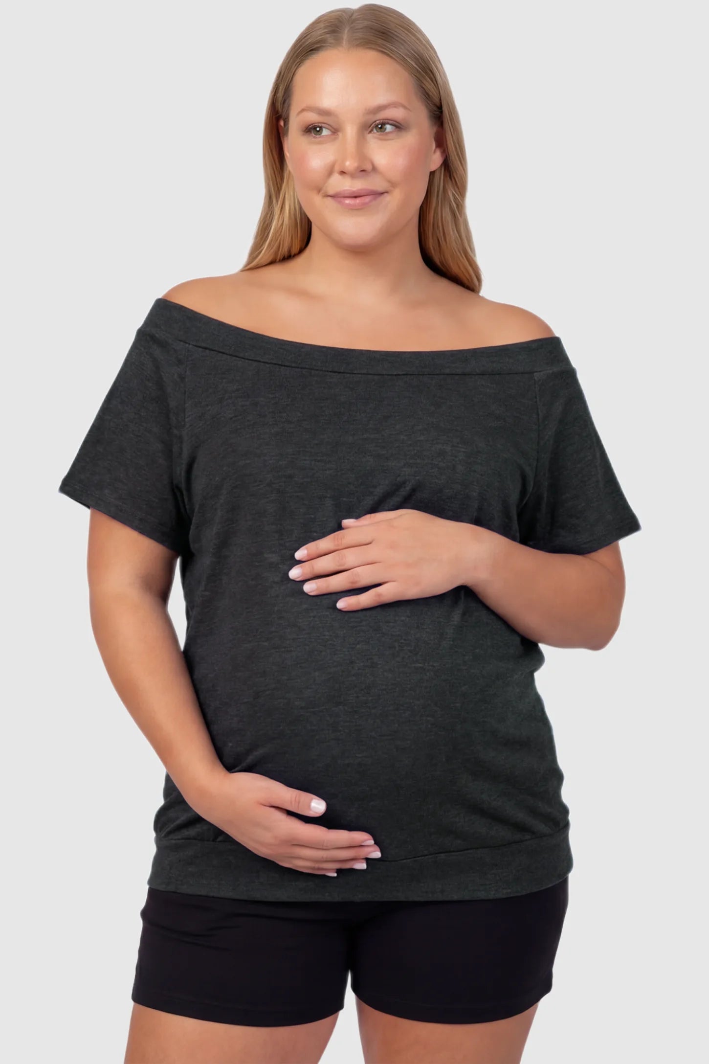 Convertible Neck Short Sleeve Maternity Top Convertible Neck Short Sleeve Maternity Top in dark gray featuring an adjustable neckline and a comfortable banded hem on a plus size pregnant model front view.