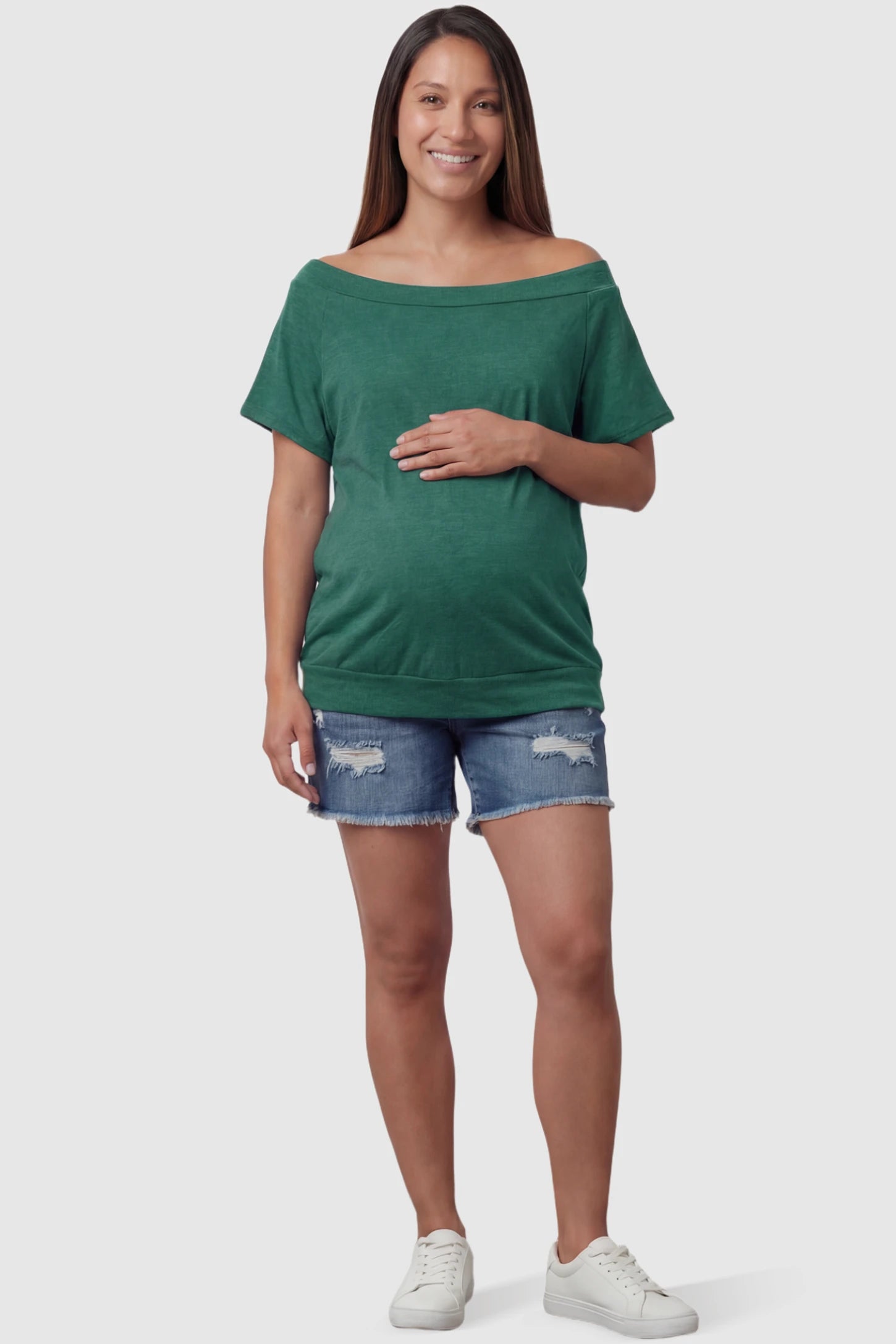 Convertible Neck Short Sleeve Maternity Top Convertible Neck Short Sleeve Maternity Top in green featuring an adjustable neckline and a comfortable banded hem on a pregnant model full body view.