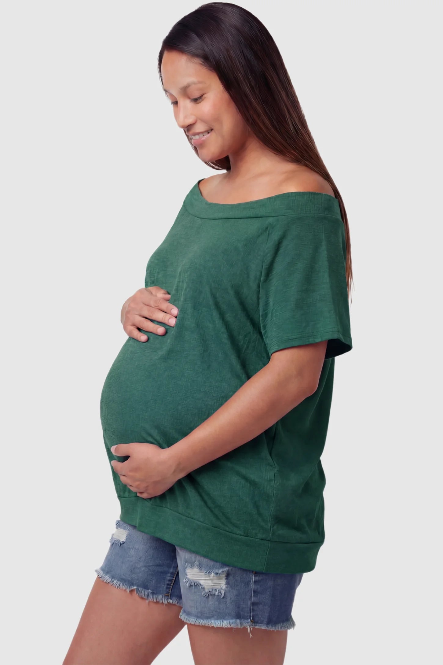 Convertible Neck Short Sleeve Maternity Top Convertible Neck Short Sleeve Maternity Top in green featuring an adjustable neckline and a comfortable banded hem on a pregnant model side view.