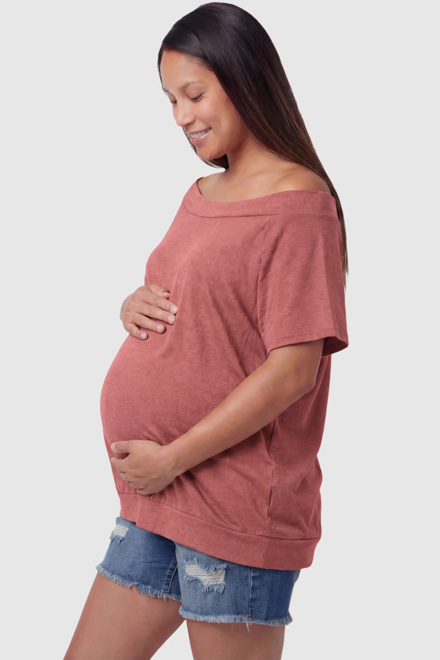 Convertible Neck Short Sleeve Maternity Top Convertible Neck Short Sleeve Maternity Top in pink featuring an adjustable neckline and a comfortable banded hem on a pregnant model side view.