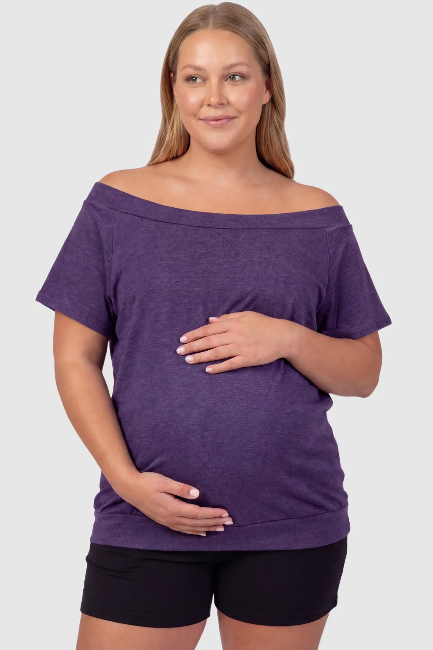 Convertible Neck Short Sleeve Maternity Top Convertible Neck Short Sleeve Maternity Top in purple featuring an adjustable neckline and a comfortable banded hem on a plus size pregnant model front view.