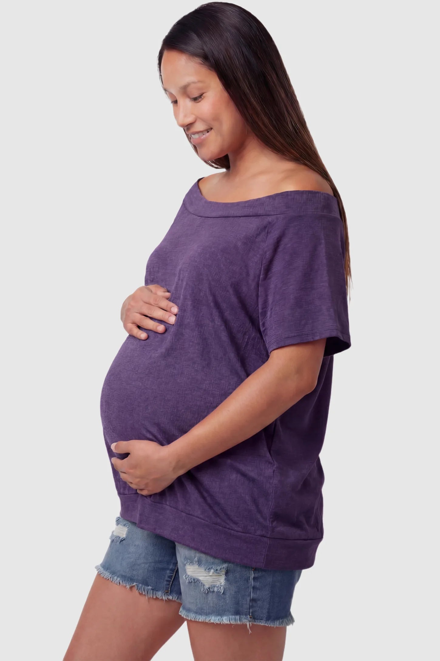 Convertible Neck Short Sleeve Maternity Top Convertible Neck Short Sleeve Maternity Top in purple featuring an adjustable neckline and a comfortable banded hem on a pregnant model side view.